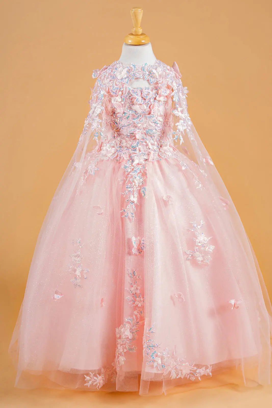 Blush kids mini quinceañera mini quince dress with 3D flower and butterfly applique bodice, sparkling tulle skirt, and flowing tunic overlay.