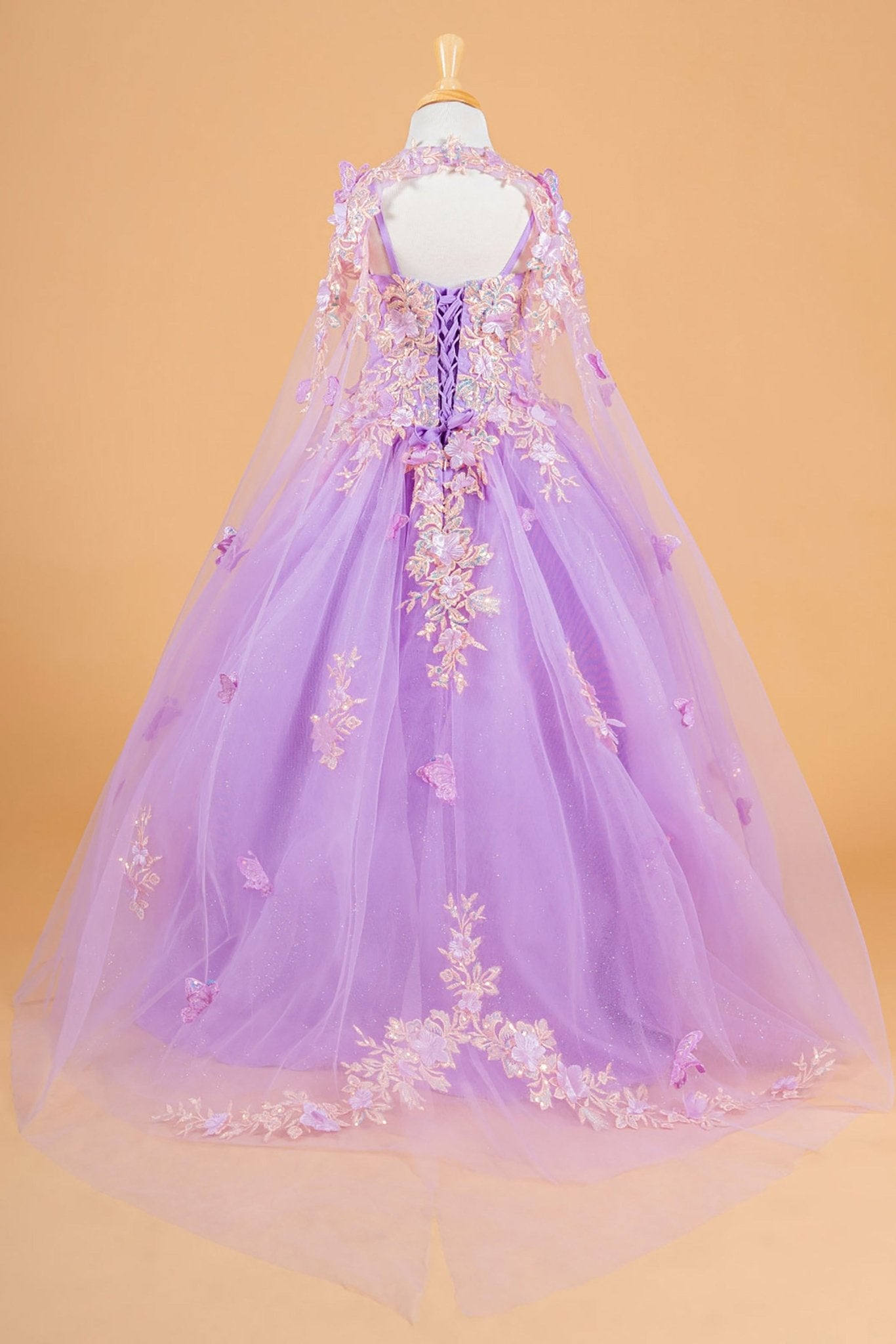 Back lilac kids mini quinceañera mini quince dress with 3D flower and butterfly appliques and matching tunic.