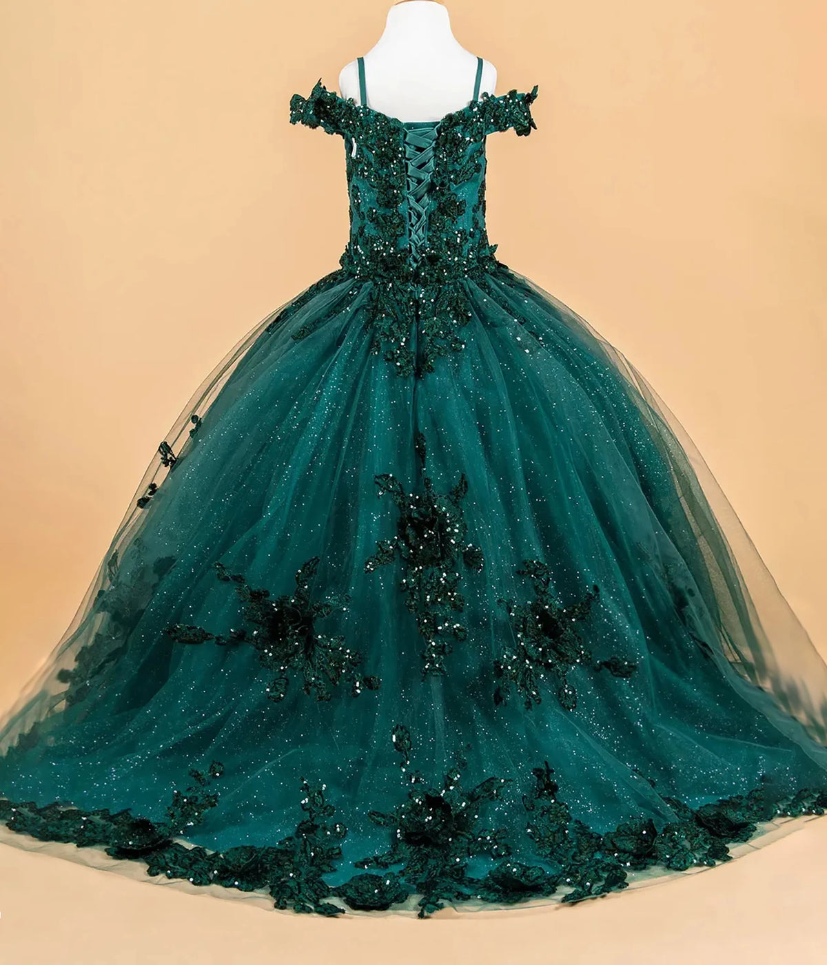 Green kids mini quince dress with black floral embellishments.