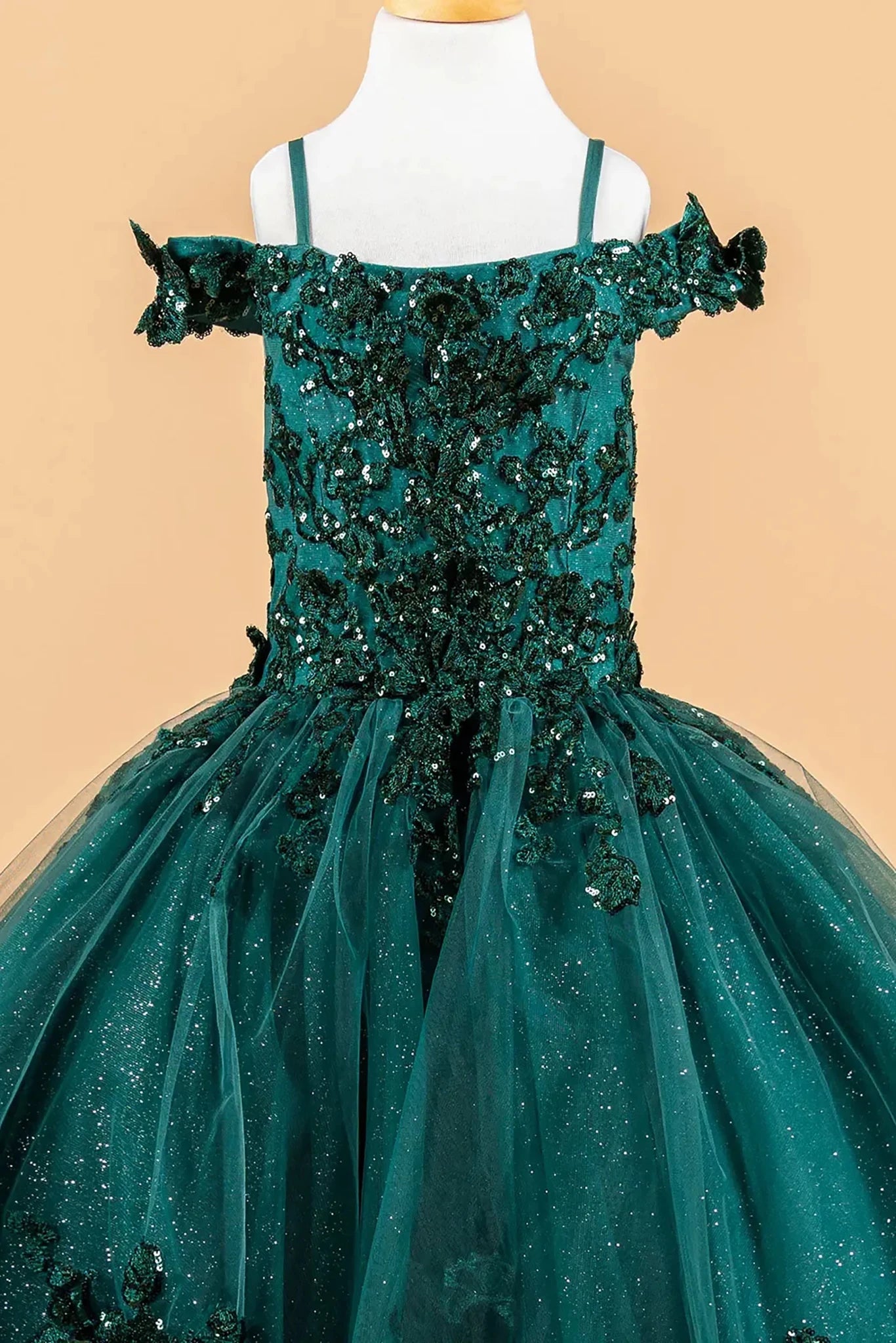 Green sequin mini quince dress displayed.