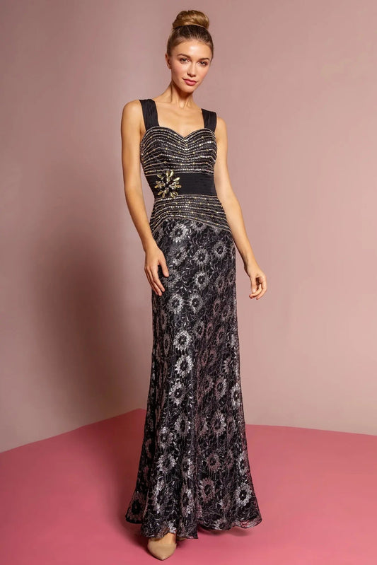 Full-length view highlights black beading embellished formal dress.