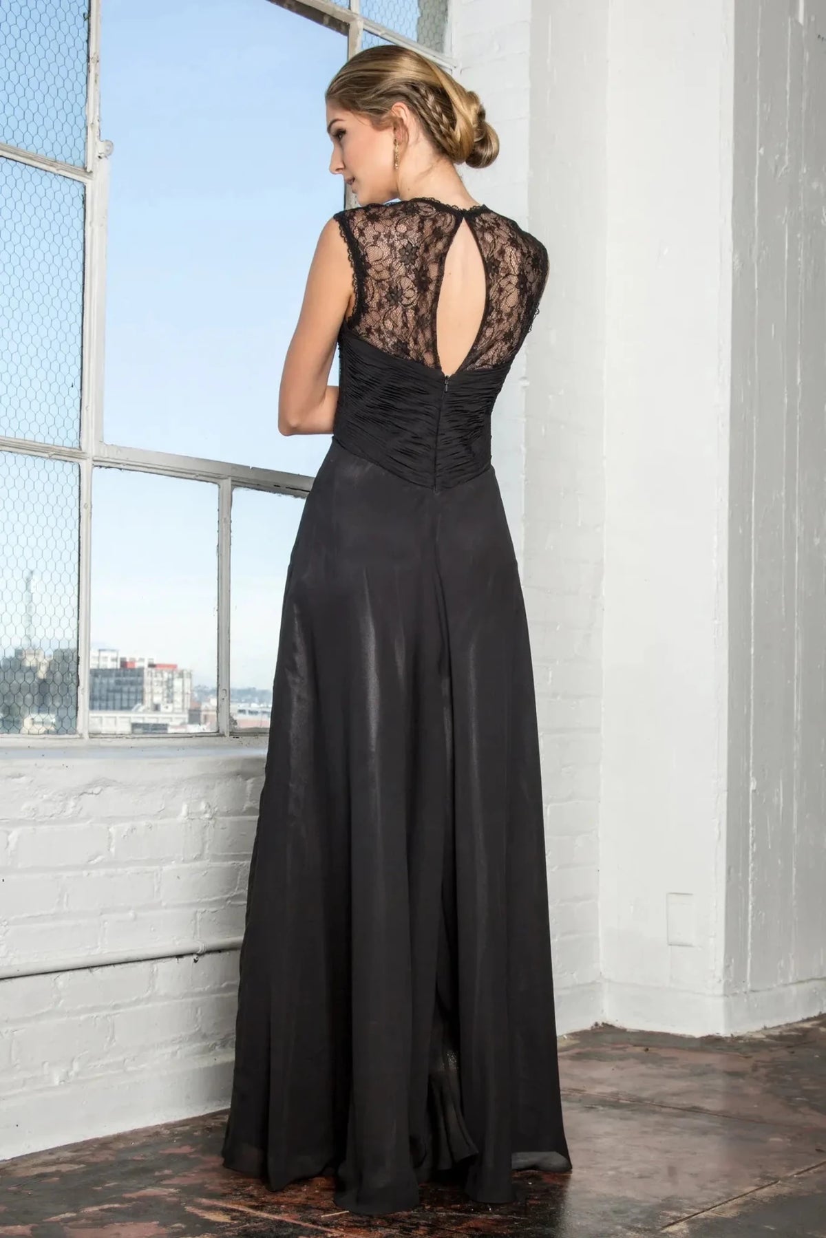 Rear view highlights the open back of the Black prom evening dress.