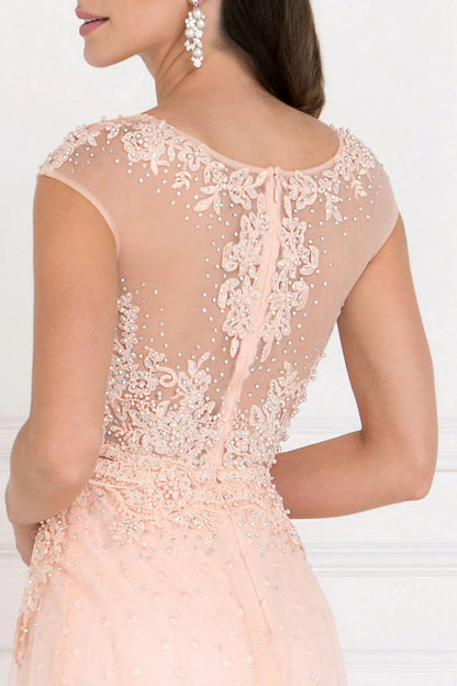 Full-length view highlights blush beading embellished embroidery formal dress.