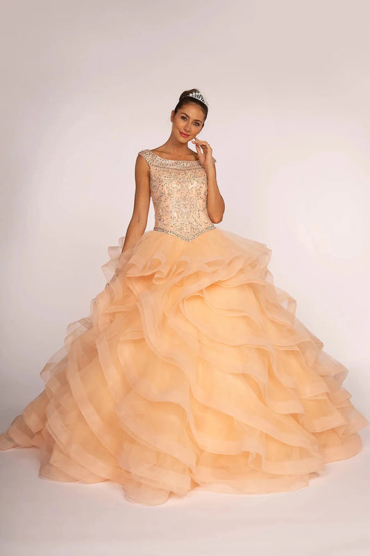 Full-length Blush quinceañera ball gown showcases a jeweled bateau bodice above cascading tulle ruffles.