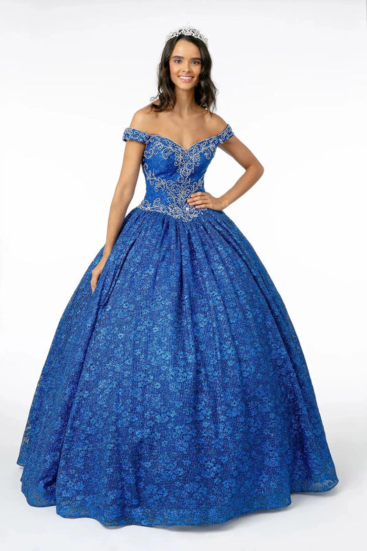 The Royal Blue quinceañera ball gown appears head to toe with a silver embroidered bodice and richly patterned blue skirt.