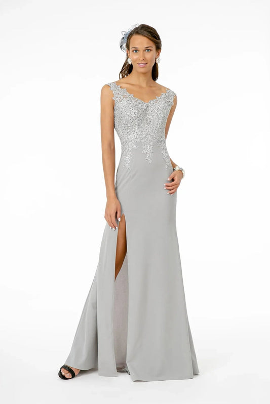 Full-length view highlights silver/Silver embroidery formal dress.