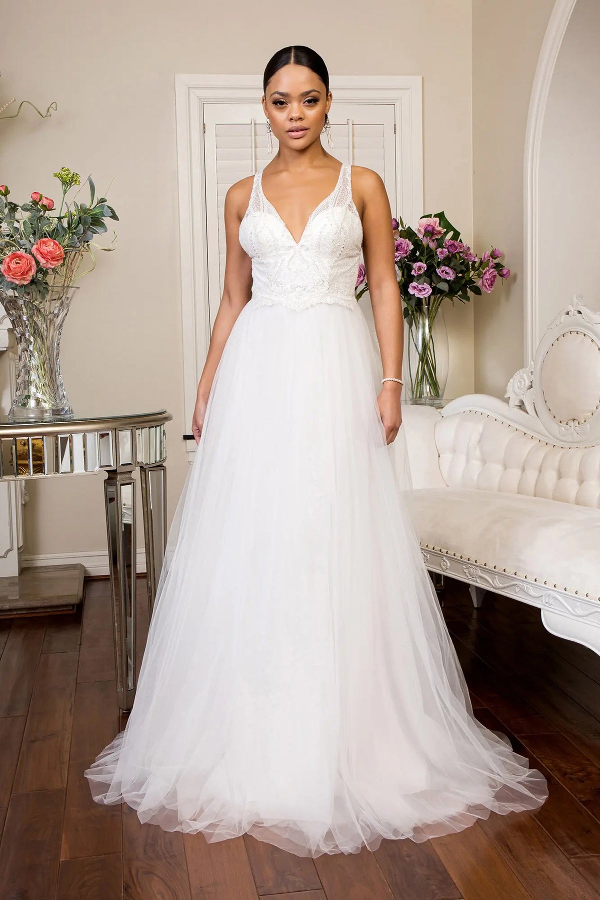 Ivory wedding gown with a beaded V-neck bodice and sweeping A-line skirt.