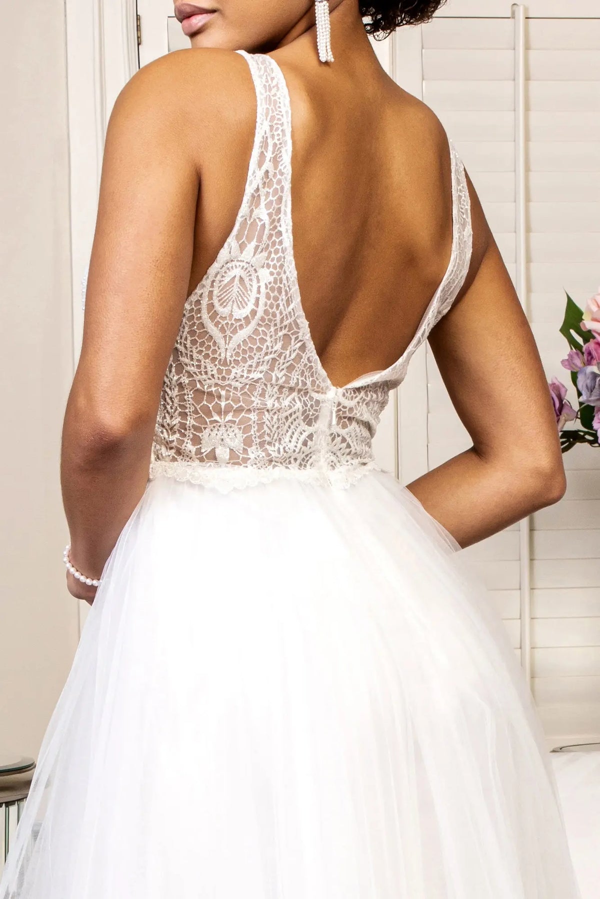 Sheer embroidered panels frame the back zipper of this ivory wedding gown.