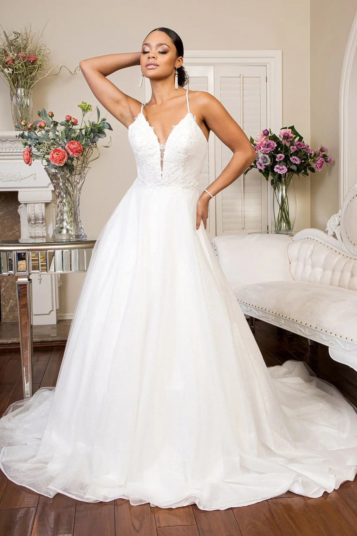 Ivory wedding gown combining an embroidered sweetheart bodice with a glittering A-line skirt.