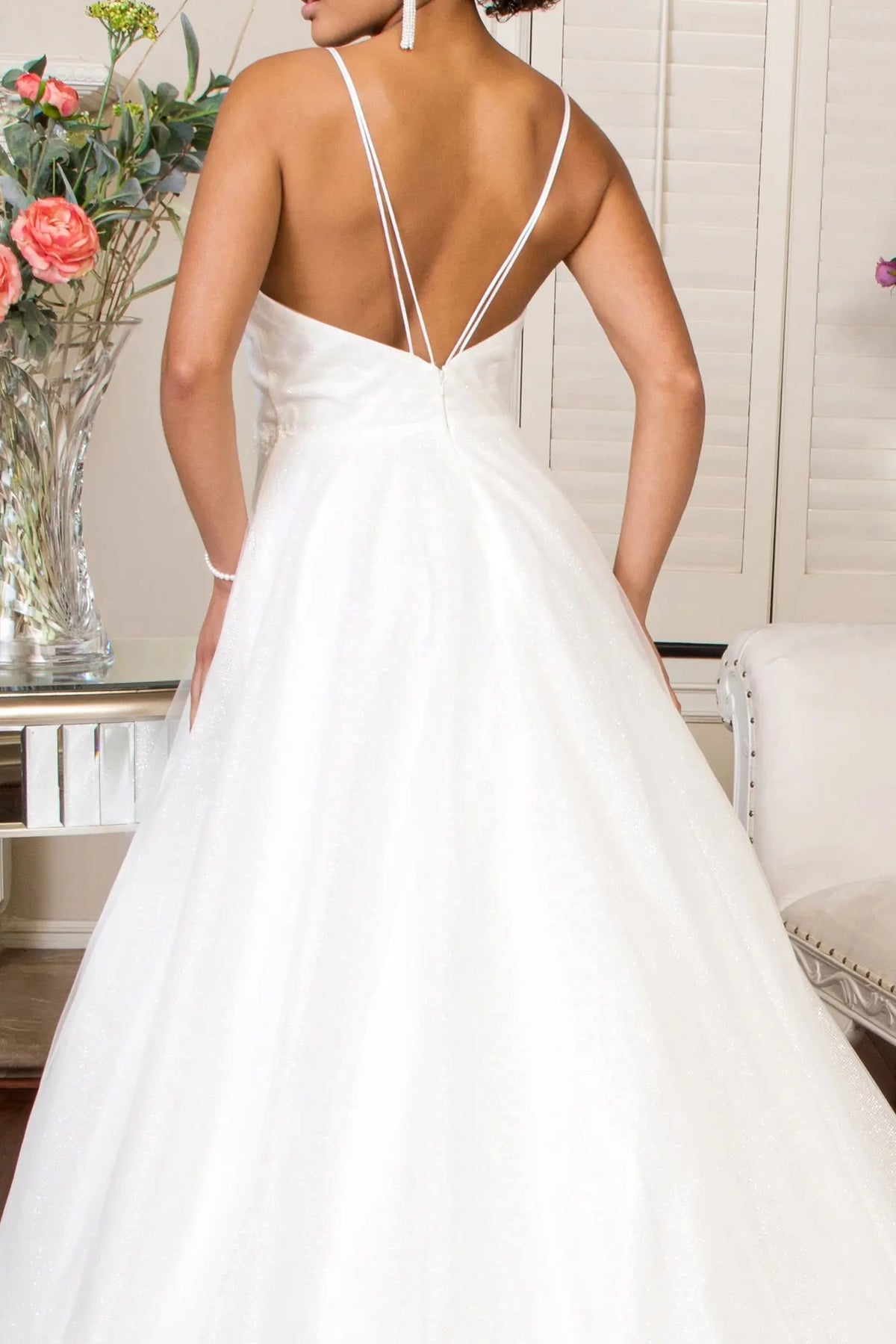 Fine straps meet the embroidered back waist of this ivory wedding gown.