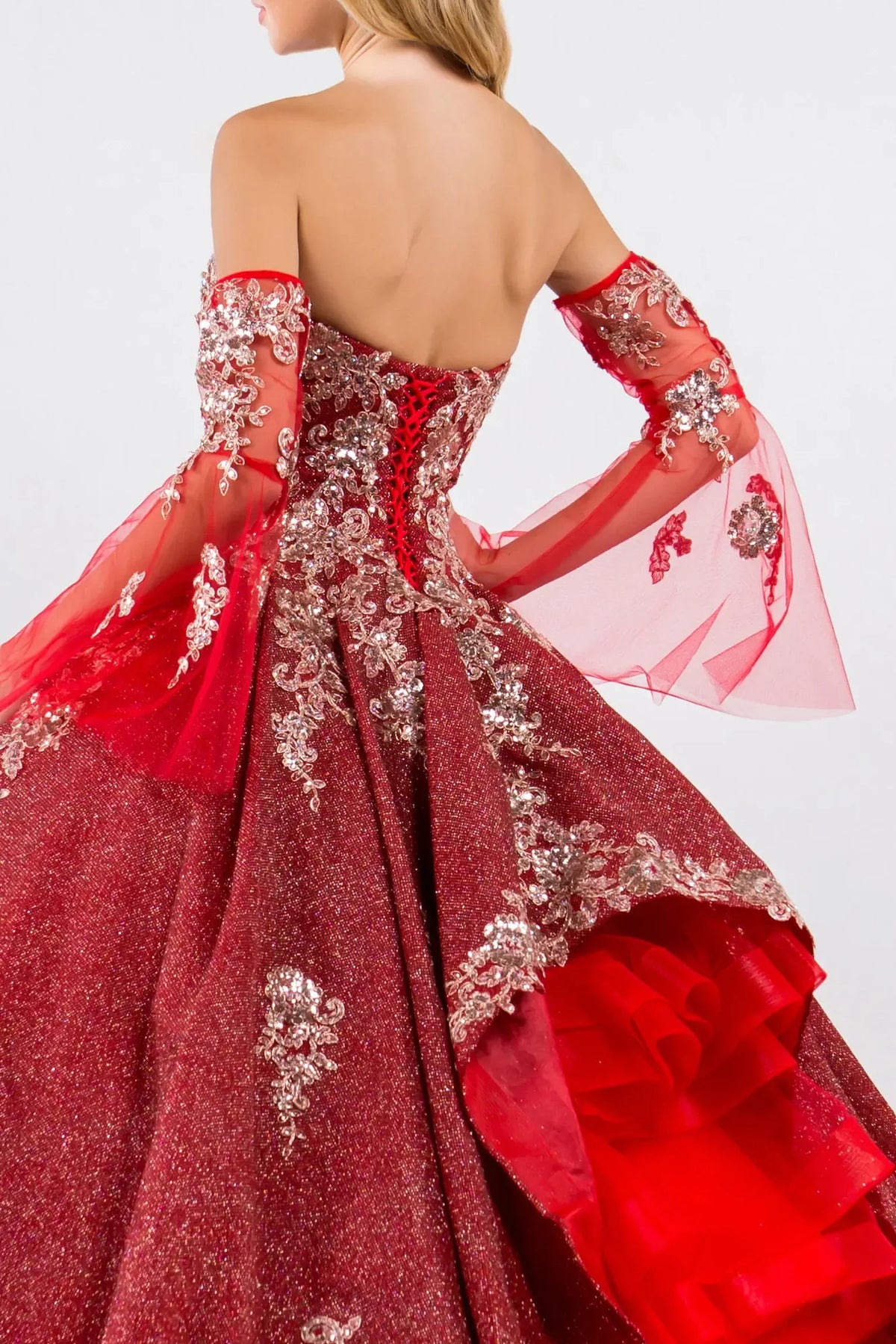 Embroidered details frame the Burgundy quinceañera ball gown with ruffled train.