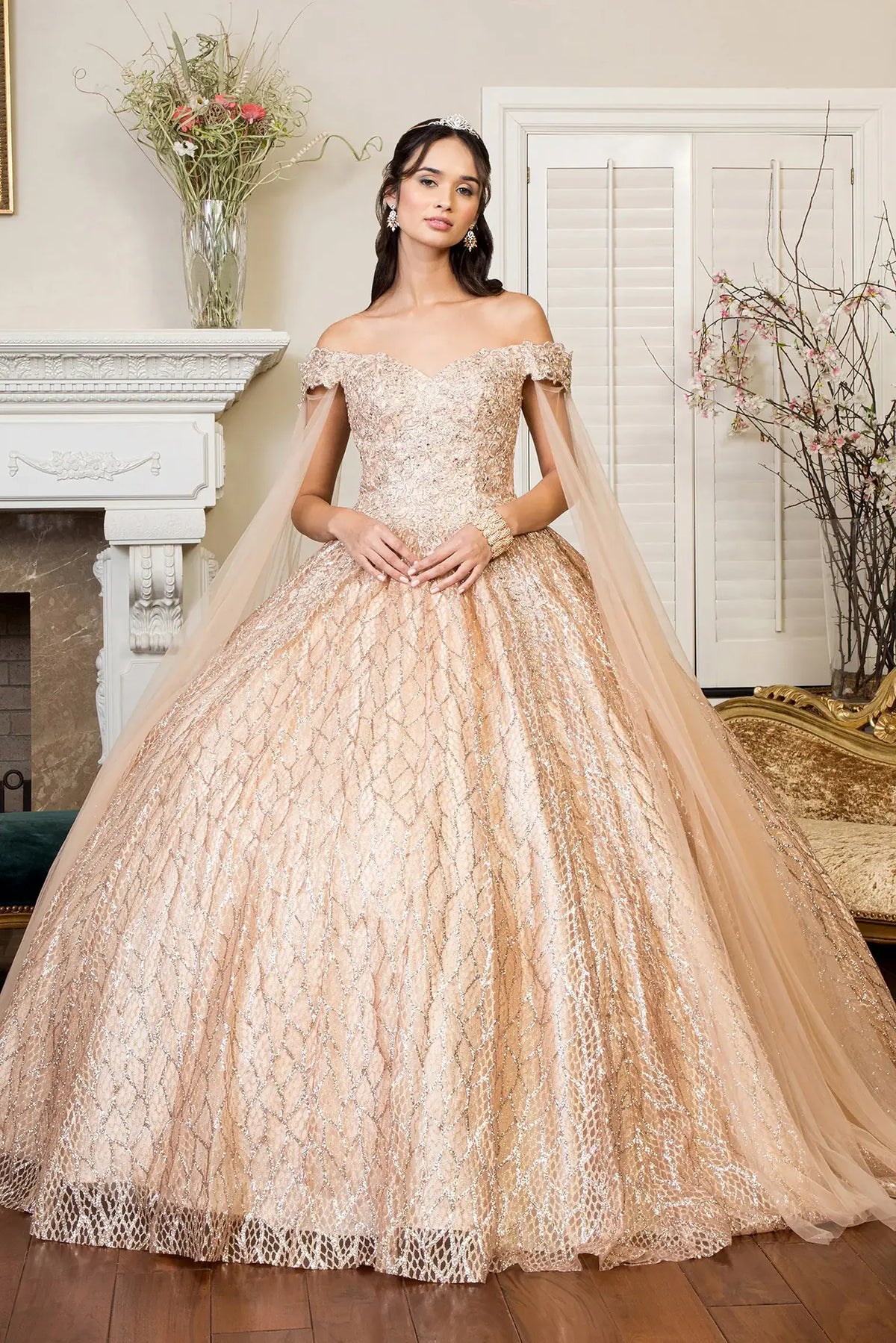 Full-length view presents the Gold quinceañera ball gown with cutaway shoulder.