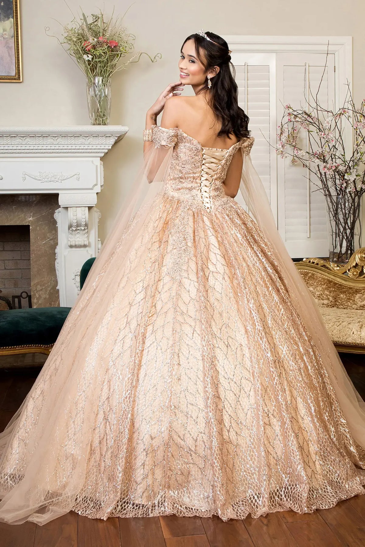 Lace-up back reveals the Gold quinceañera ball gown with lace-up back and glitter mesh skirt.