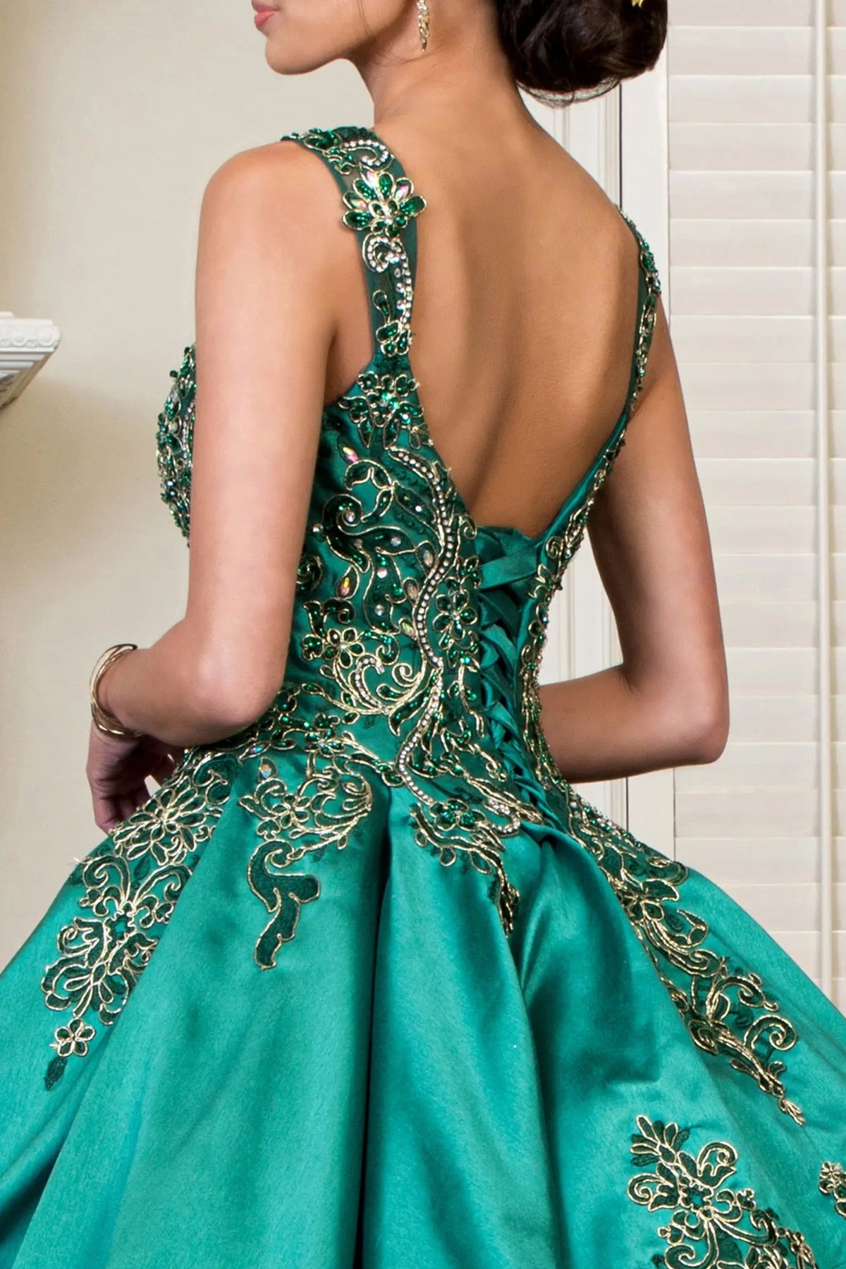 Embroidered details frame the Green quinceañera ball gown with metallic embroidery.