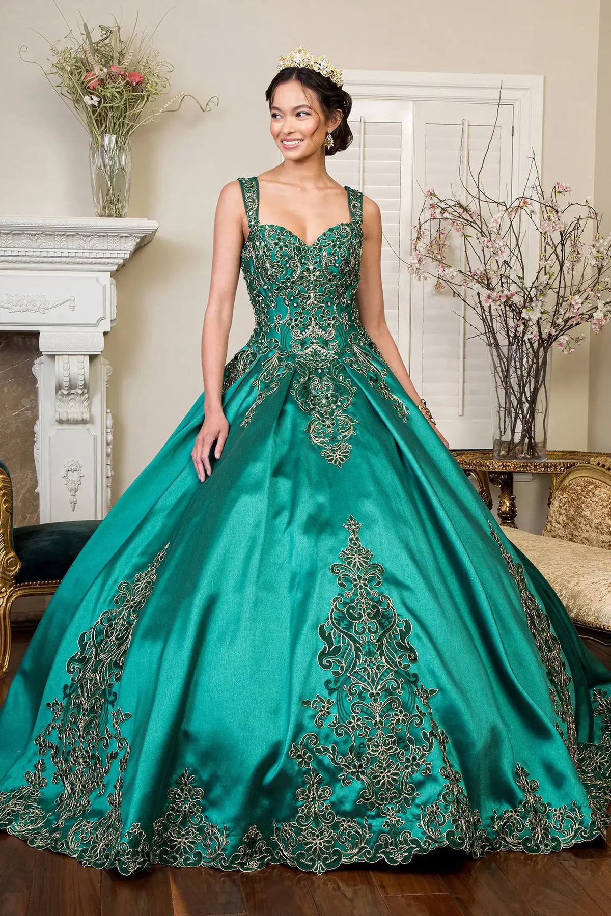 Layered skirt showcases the Green quinceañera ball gown with metallic embroidery.