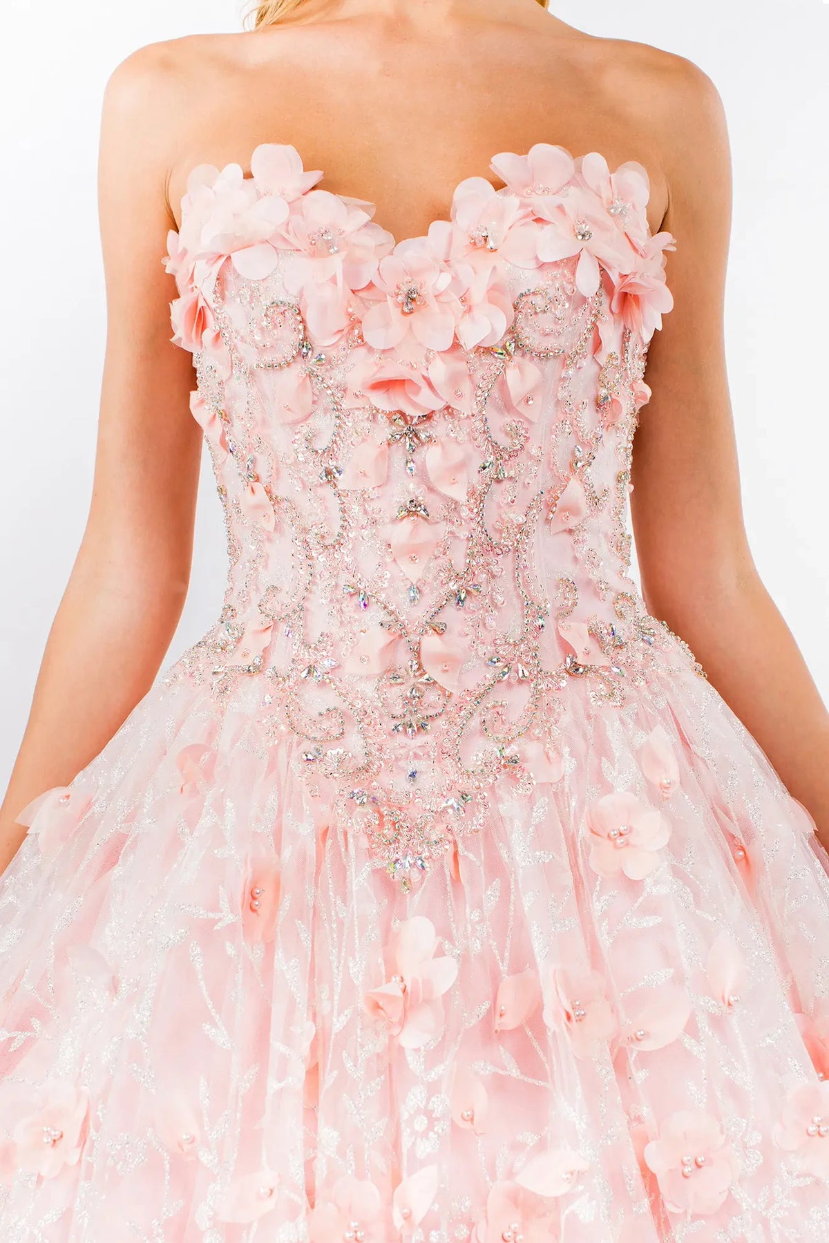Layered skirt showcases the Blush quinceañera ball gown with 3d floral cape.