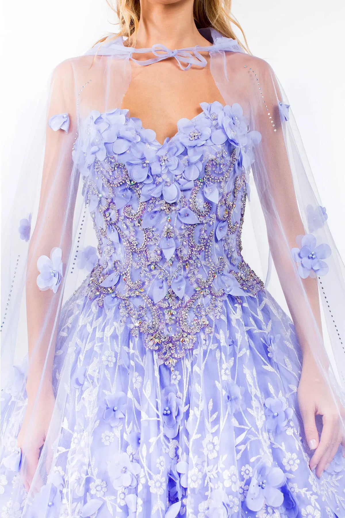 Embroidered details frame the Lilac quinceañera ball gown with 3d floral cape.