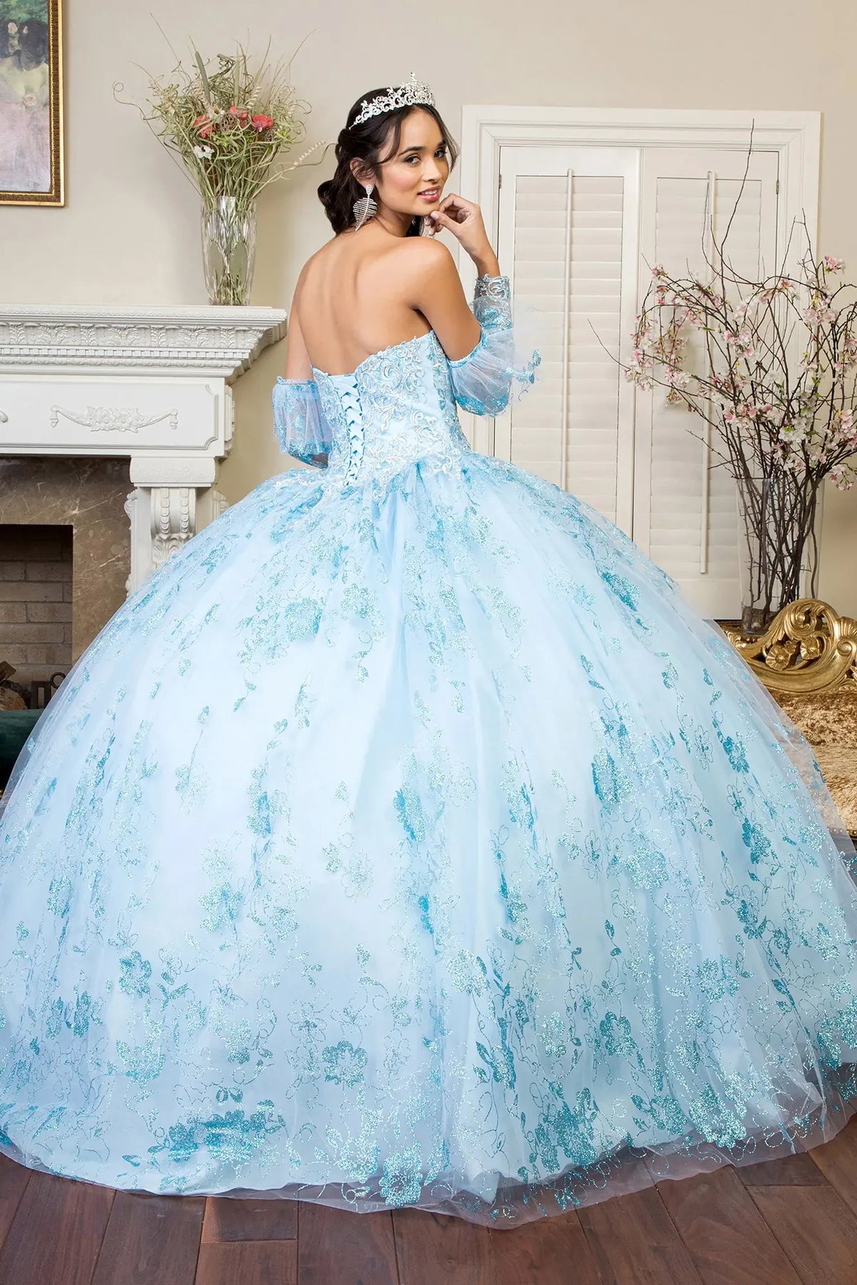 Lace-up back reveals the Baby Blue quinceañera ball gown with lace-up back and glitter embroidery.