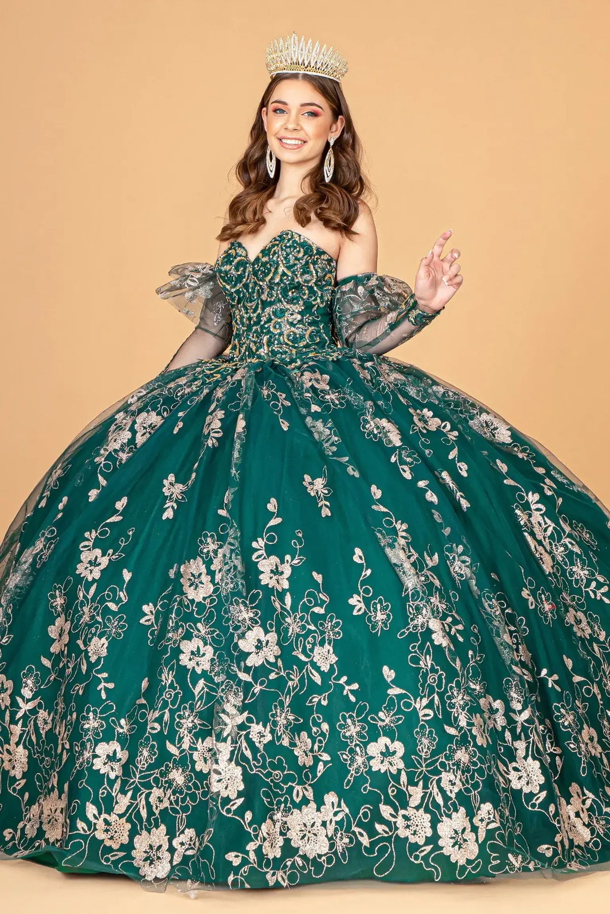 Embroidered details frame the Emerald Green quinceañera ball gown with detachable long sleeves.