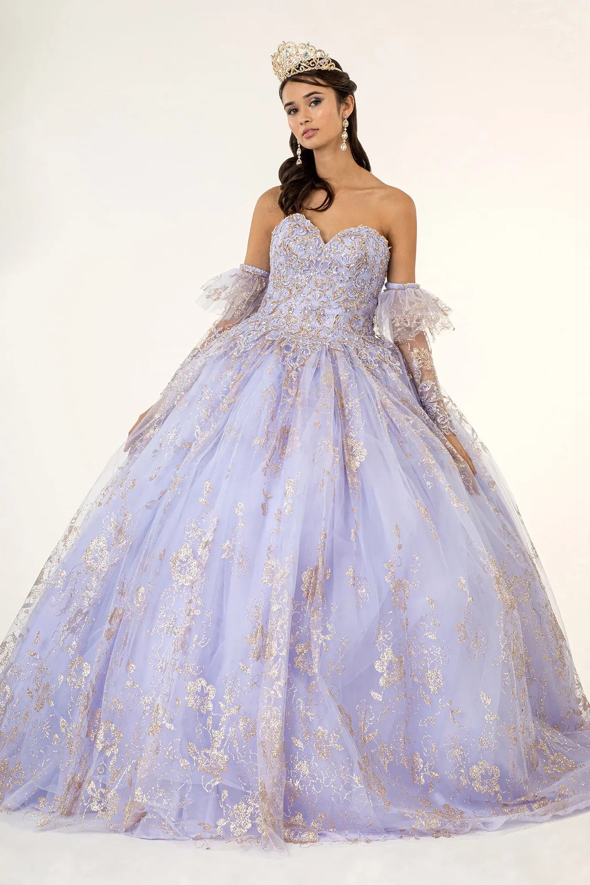 Layered skirt showcases the Lilac quinceañera ball gown with detachable long sleeves.