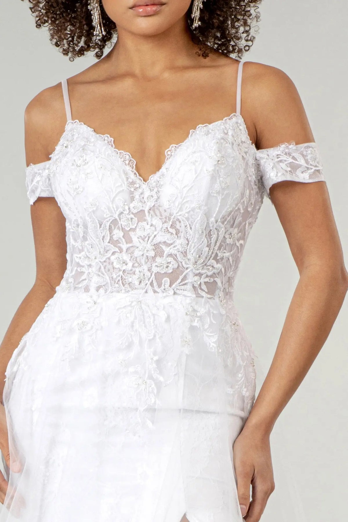 Draped shoulder bands frame the beaded sweetheart bodice on this white wedding gown.