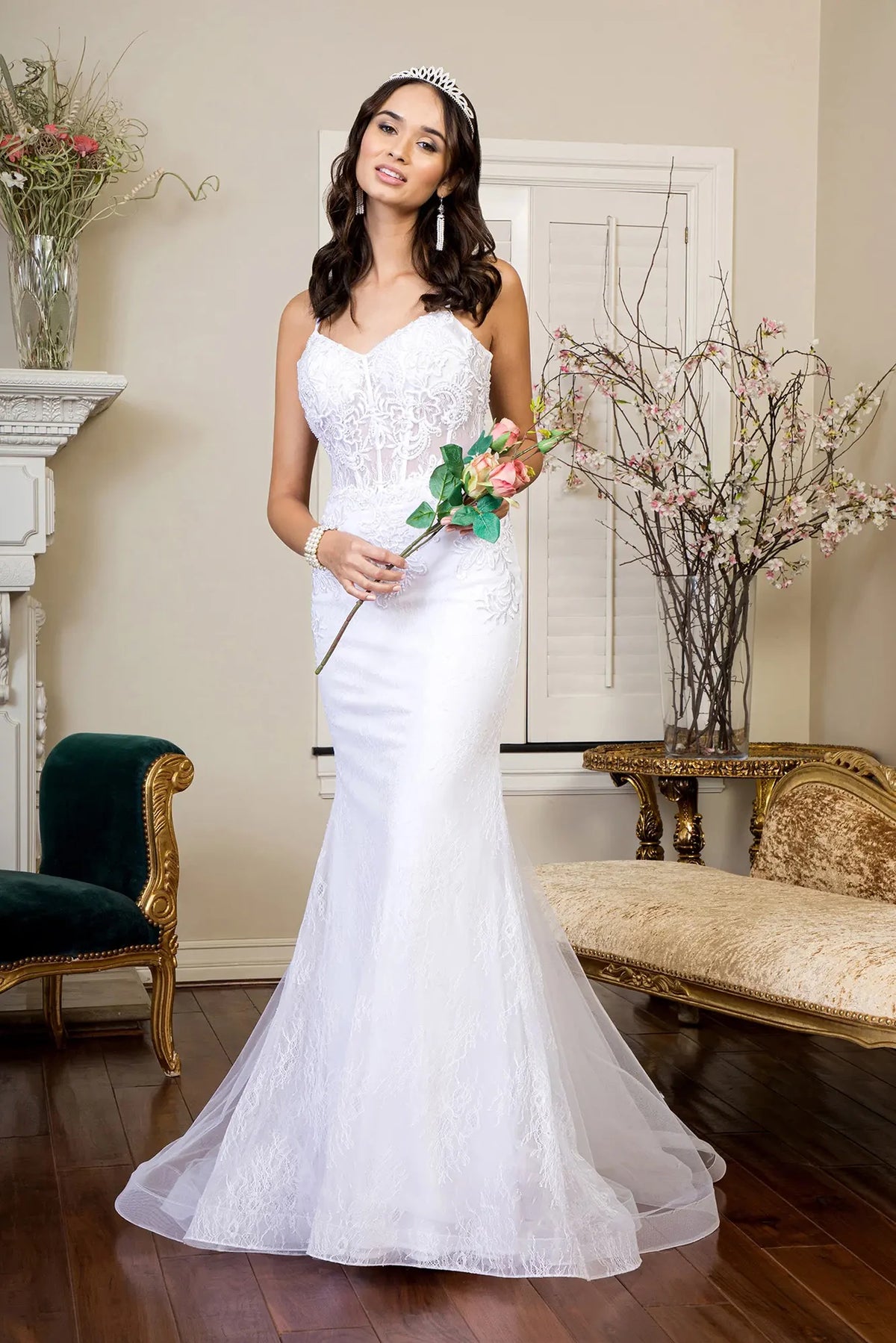 White wedding gown with an embroidered fitted silhouette and softly flared mermaid hem.