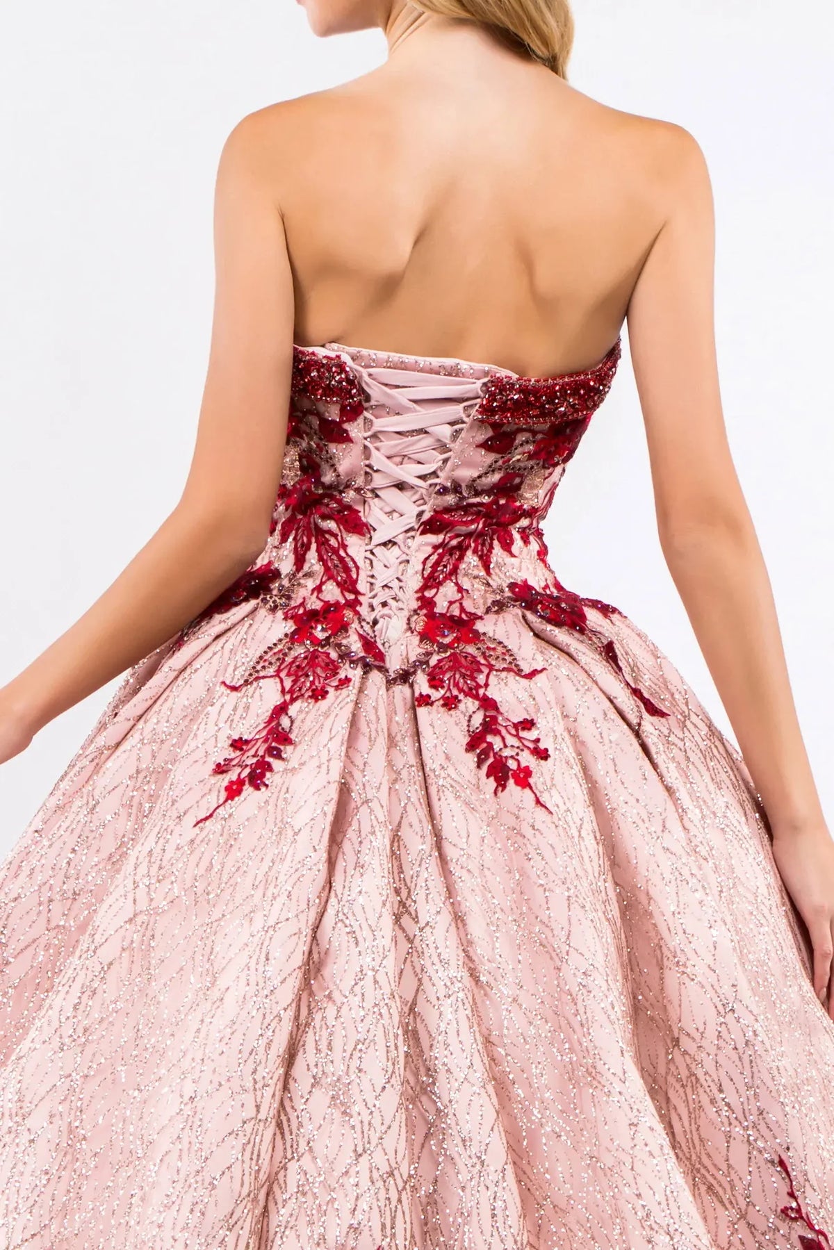 Embroidered details frame the Rose Gold quinceañera ball gown with glitter mesh.