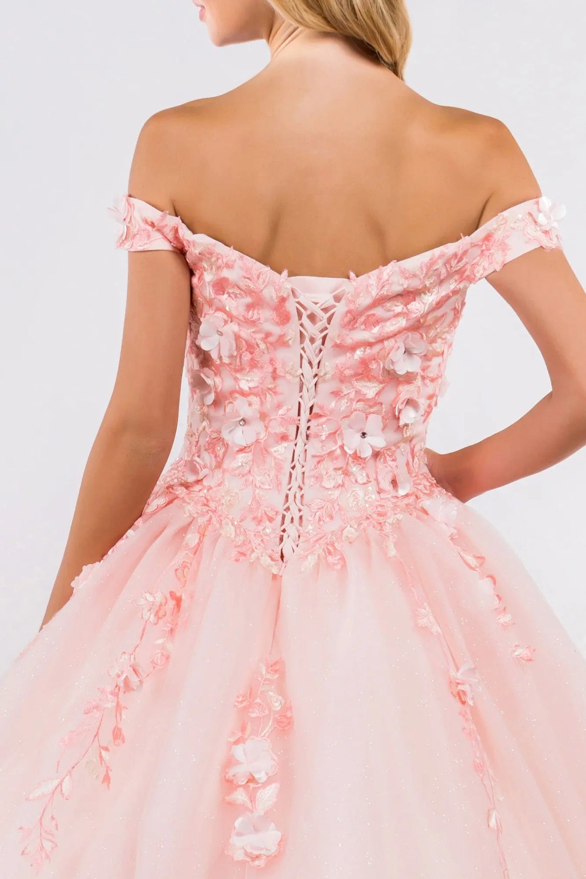Embroidered details frame the Blush quinceañera ball gown with 3d floral appliqués.