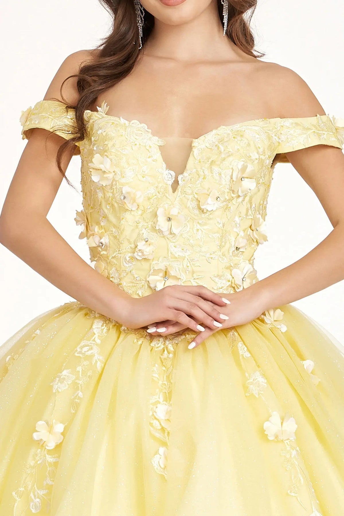 Embroidered details frame the Yellow quinceañera ball gown with 3d floral appliqués.