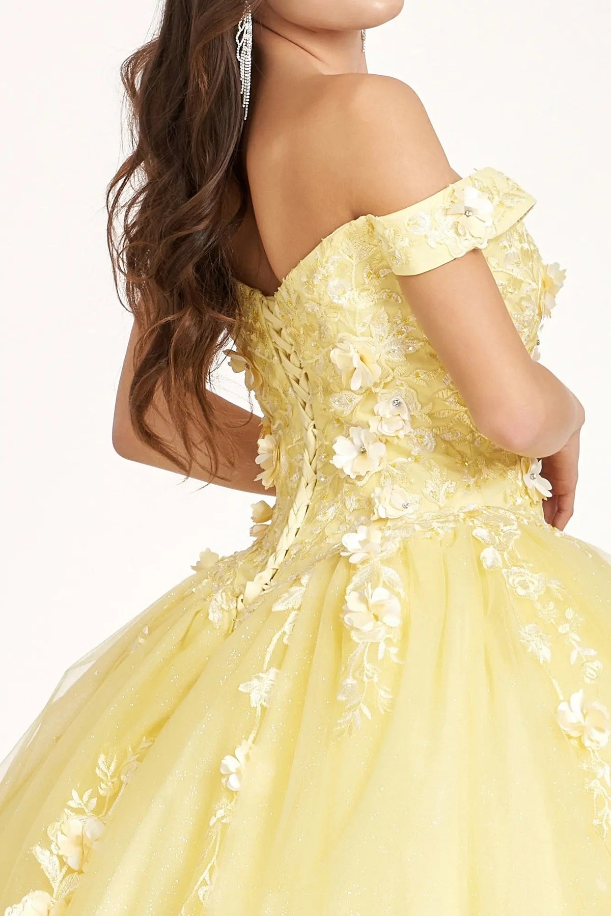 Layered skirt showcases the Yellow quinceañera ball gown with 3d floral appliqués.