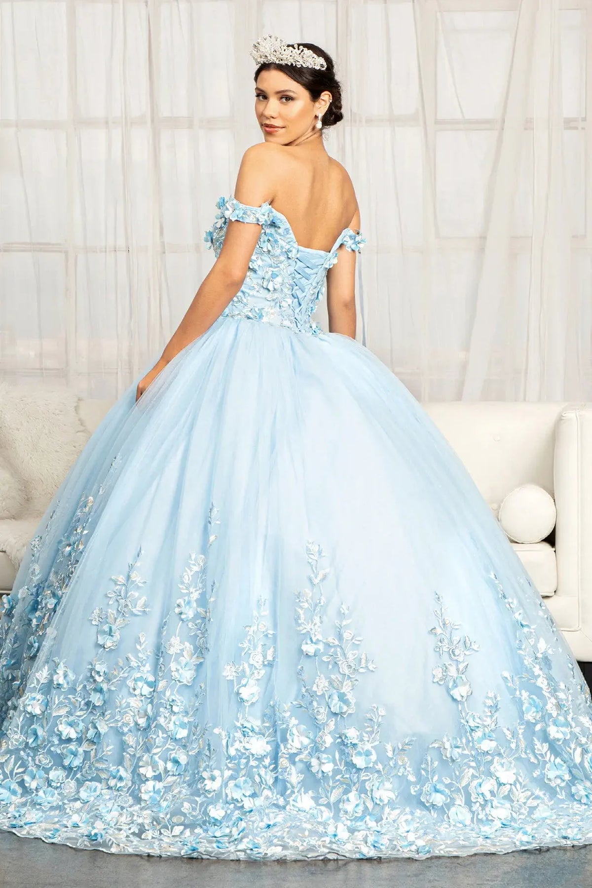 Bodice close-up highlights the Baby Blue quinceañera ball gown with cutaway shoulder detail.