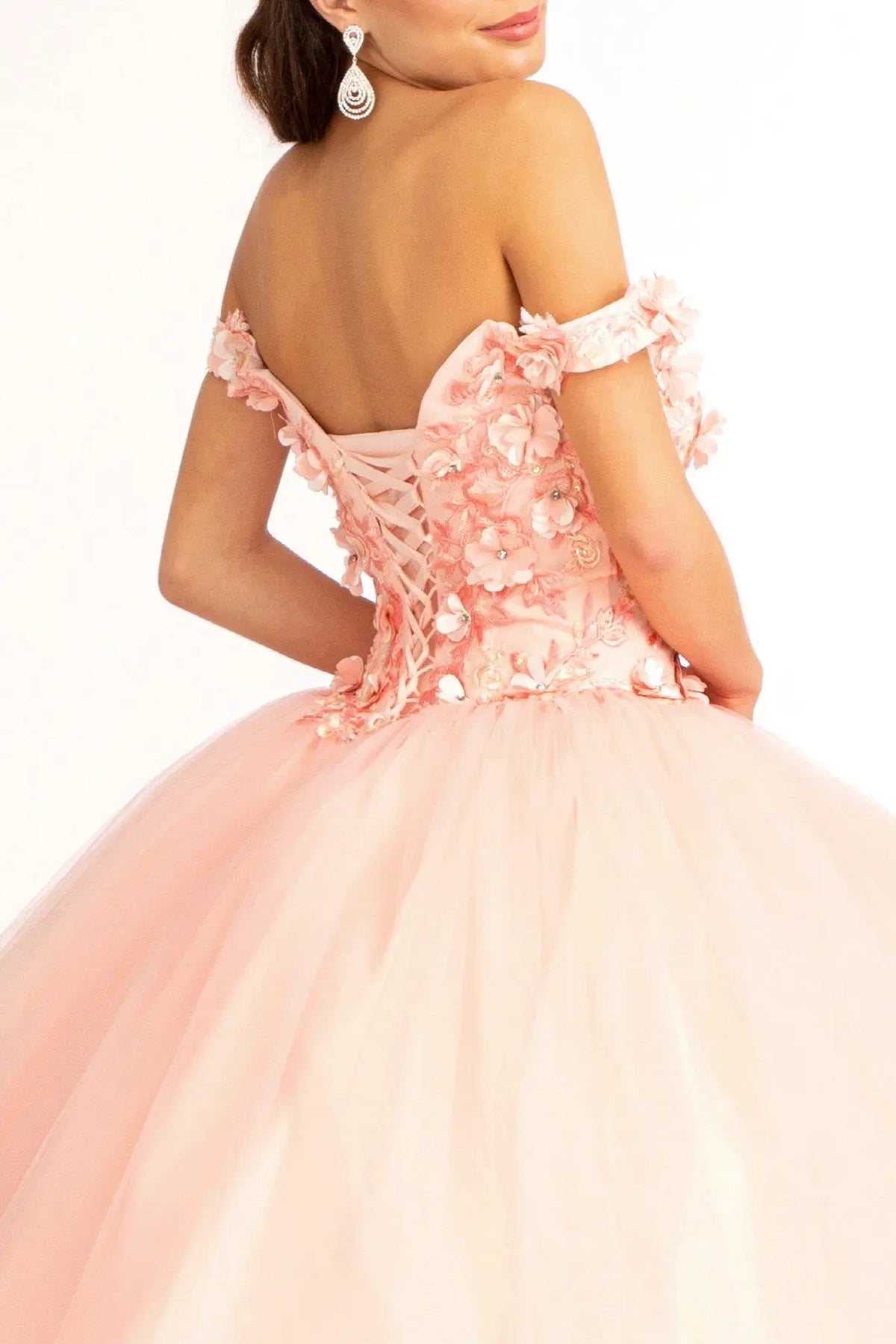 Embroidered details frame the Blush quinceañera ball gown with 3d floral appliqués.