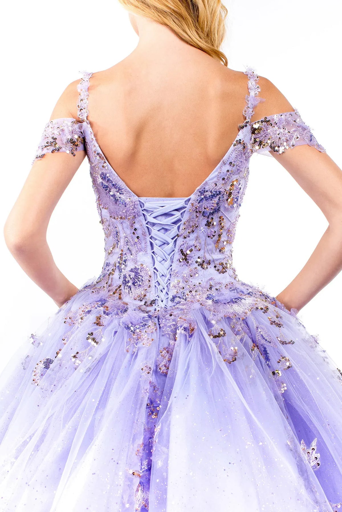 Layered skirt showcases the Lilac quinceañera ball gown with glitter embroidery.