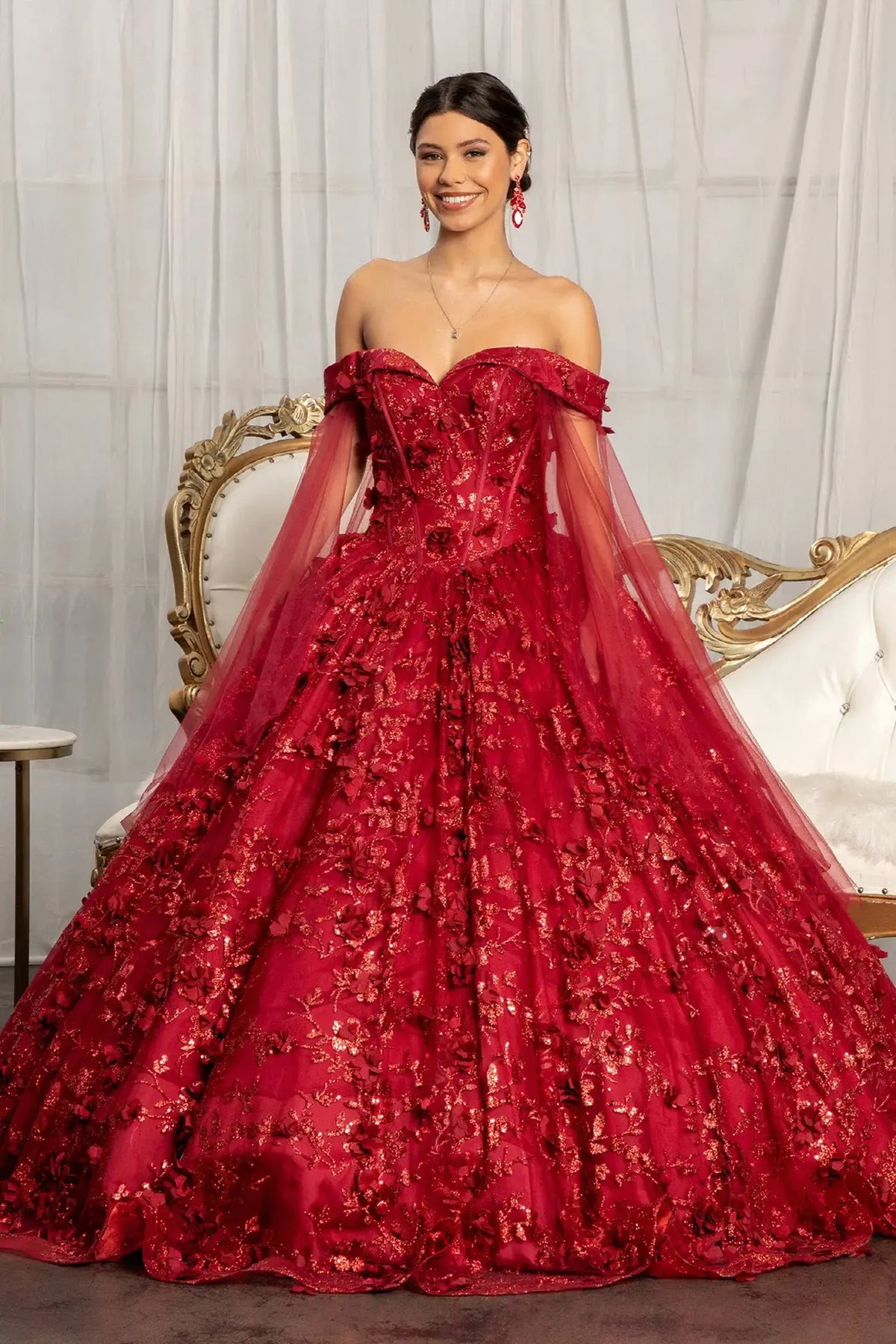 Lace-up back reveals the Burgundy quinceañera ball gown with lace-up back and draped shoulder mesh.