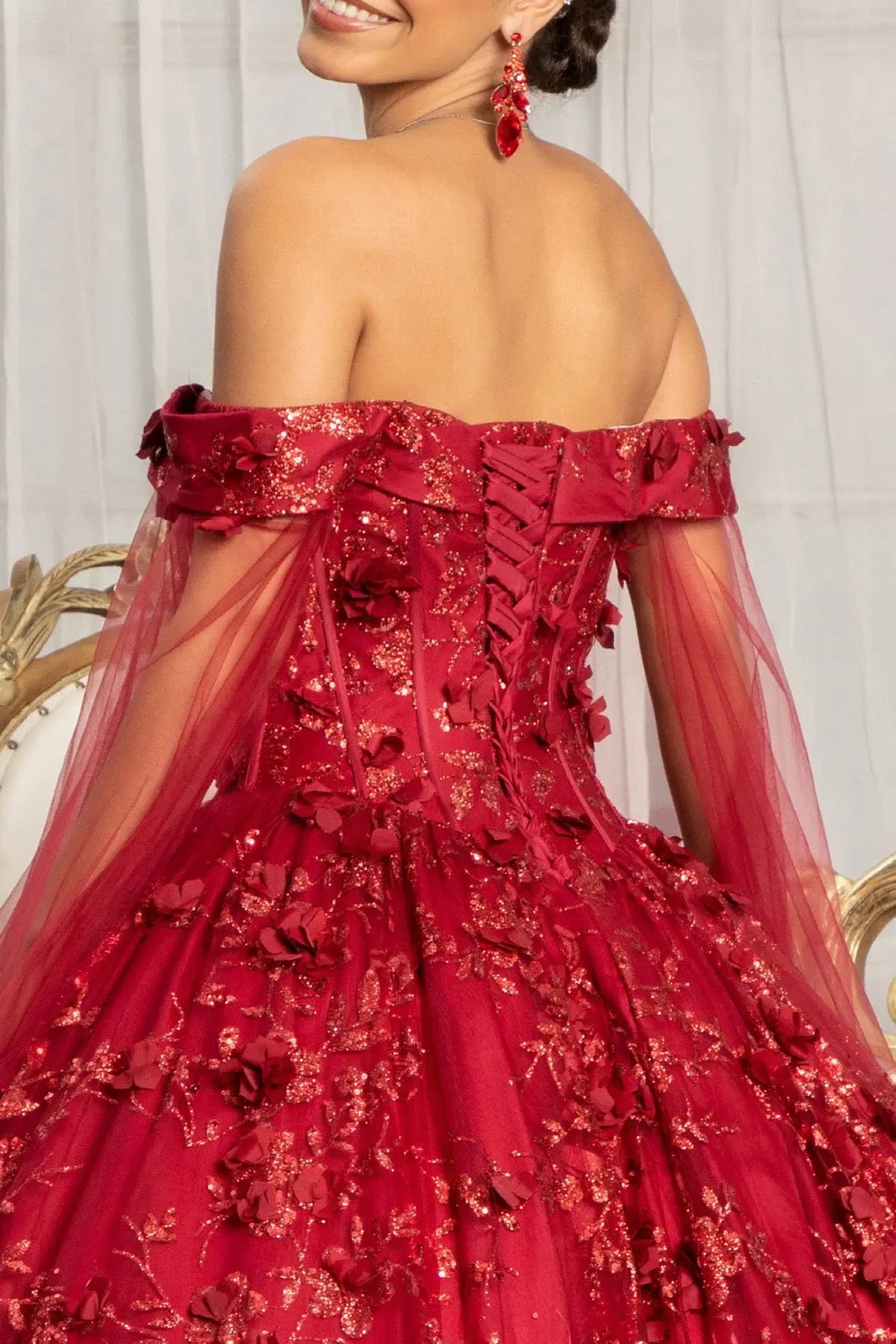 Embroidered details frame the Burgundy quinceañera ball gown with 3d floral appliqués.