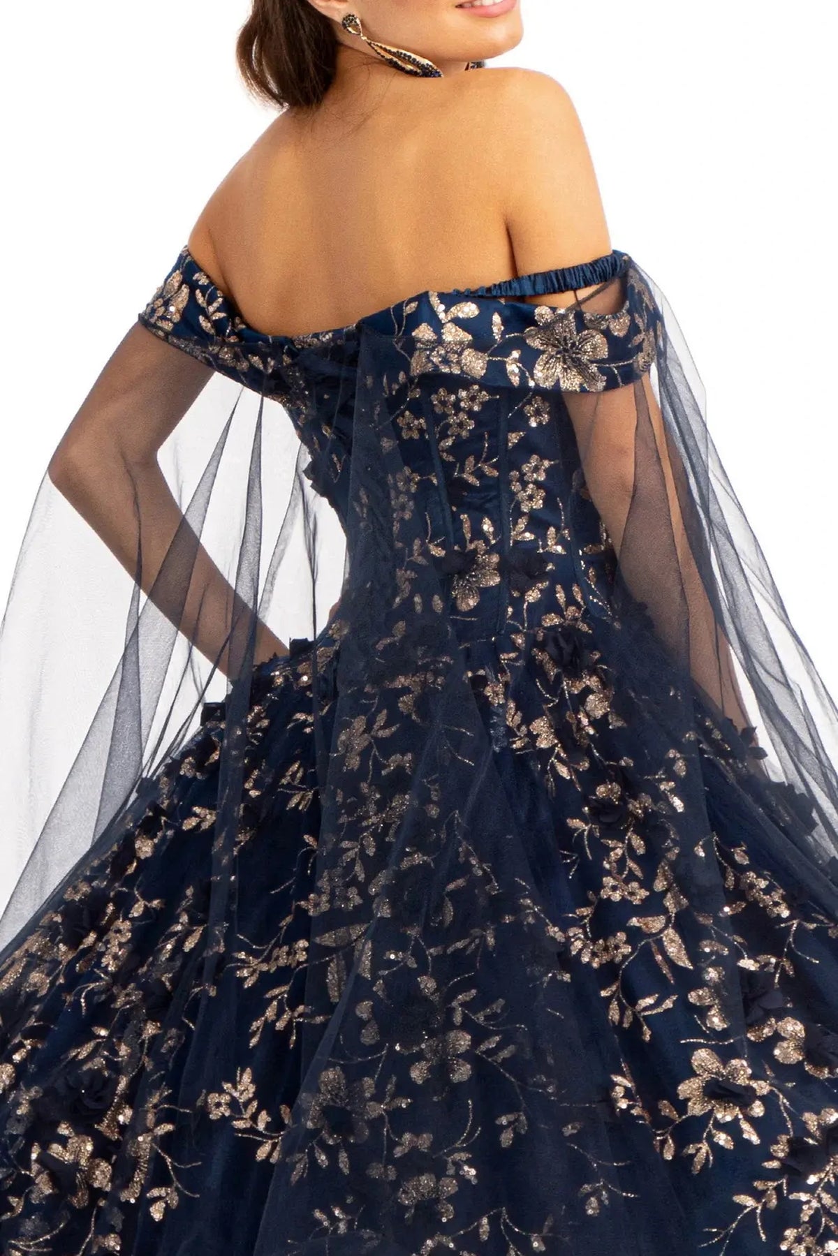 Layered skirt showcases the Navy quinceañera ball gown with 3d floral appliqués.