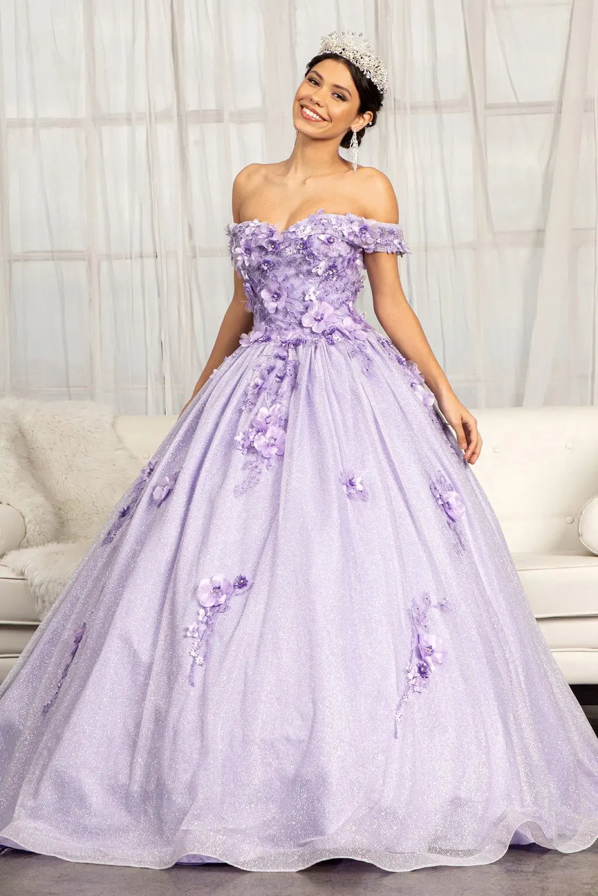 Embroidered details frame the Lilac quinceañera ball gown with 3d floral appliqués.