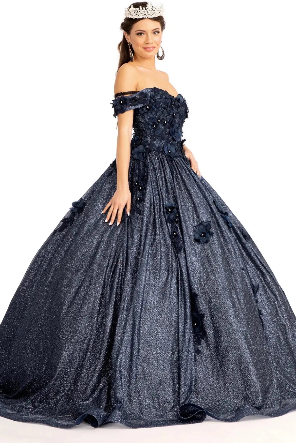 Embroidered details frame the Navy quinceañera ball gown with 3d floral appliqués.