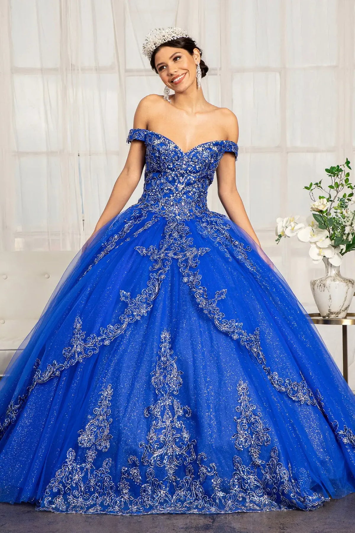 Lace-up back reveals the Royal Blue quinceañera ball gown with lace-up back and cutaway shoulder detail.