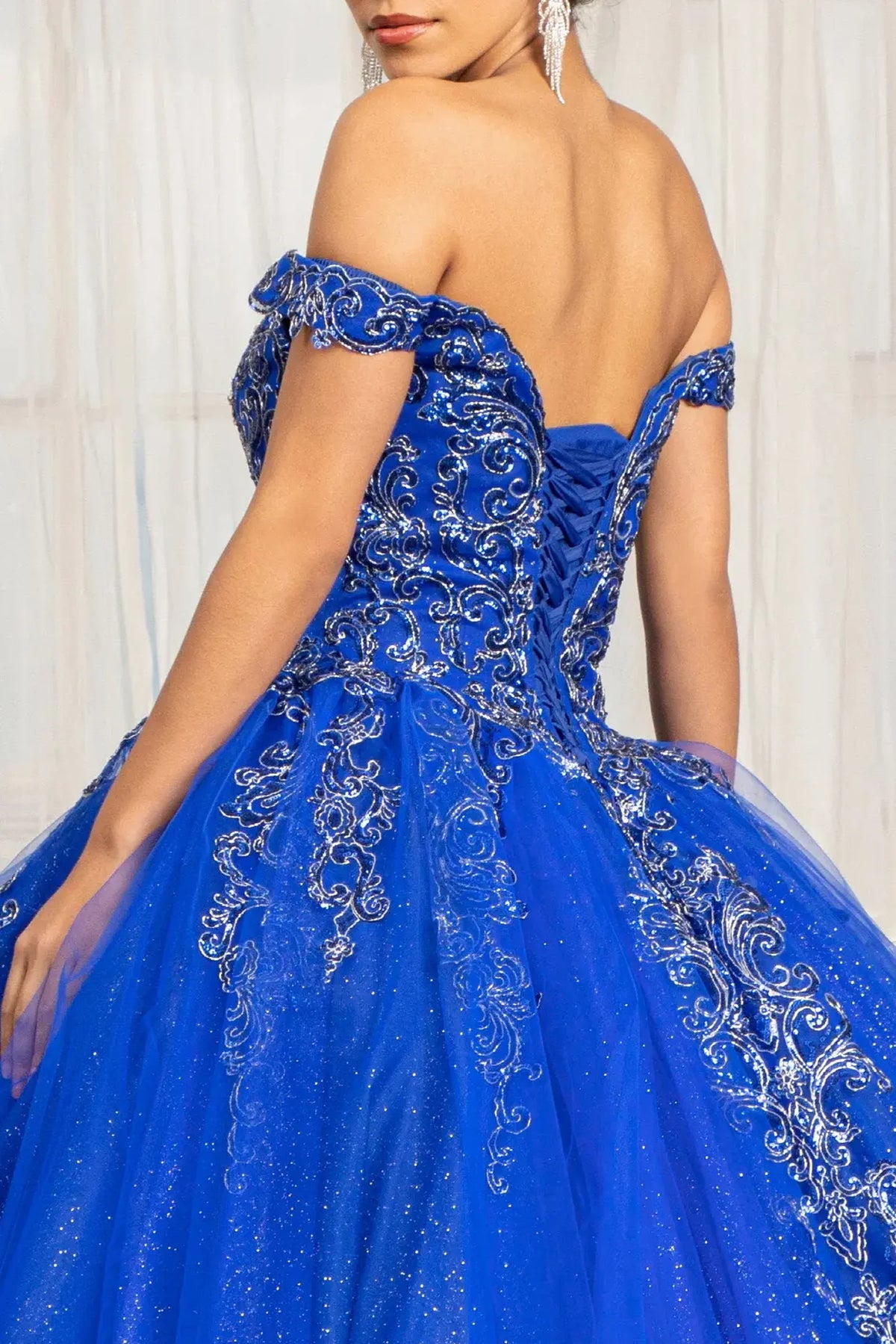 Embroidered details frame the Royal Blue quinceañera ball gown with glitter embroidery.