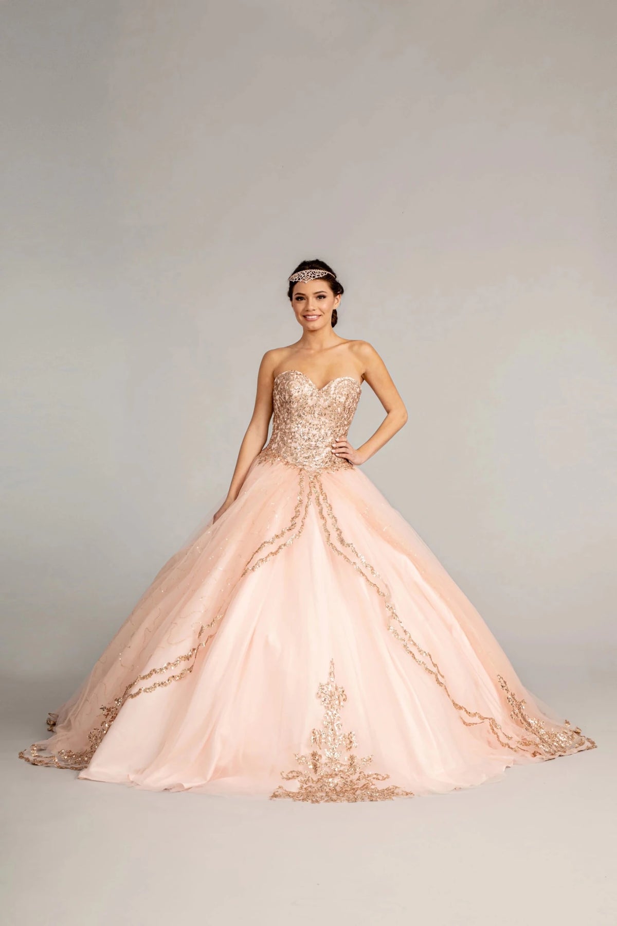 Full-length view presents the Blush quinceañera ball gown with glitter sequins.