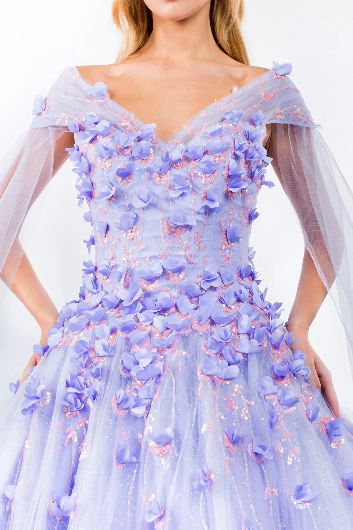 Embroidered details frame the Lilac quinceañera ball gown with detachable cape sleeves.