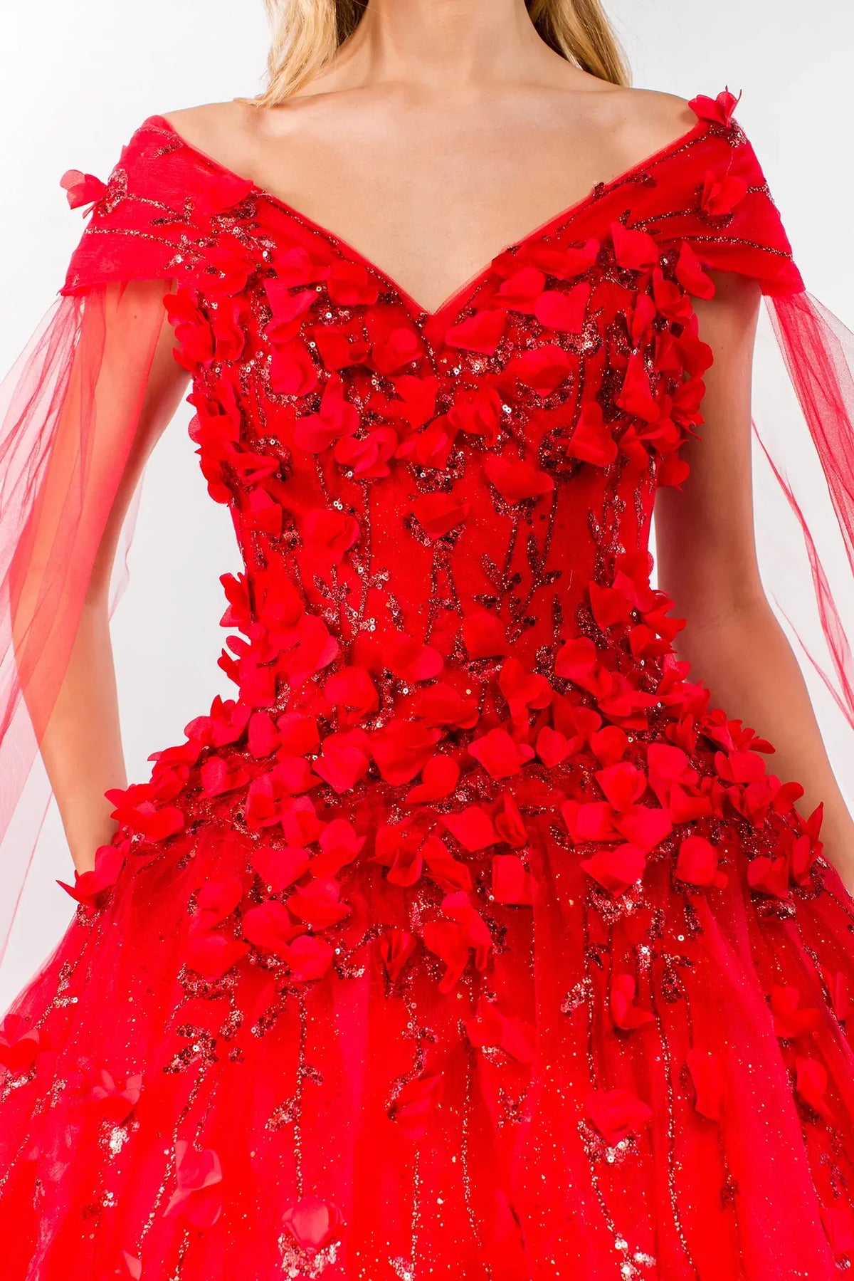 Embroidered details frame the Red quinceañera ball gown with detachable cape sleeves.