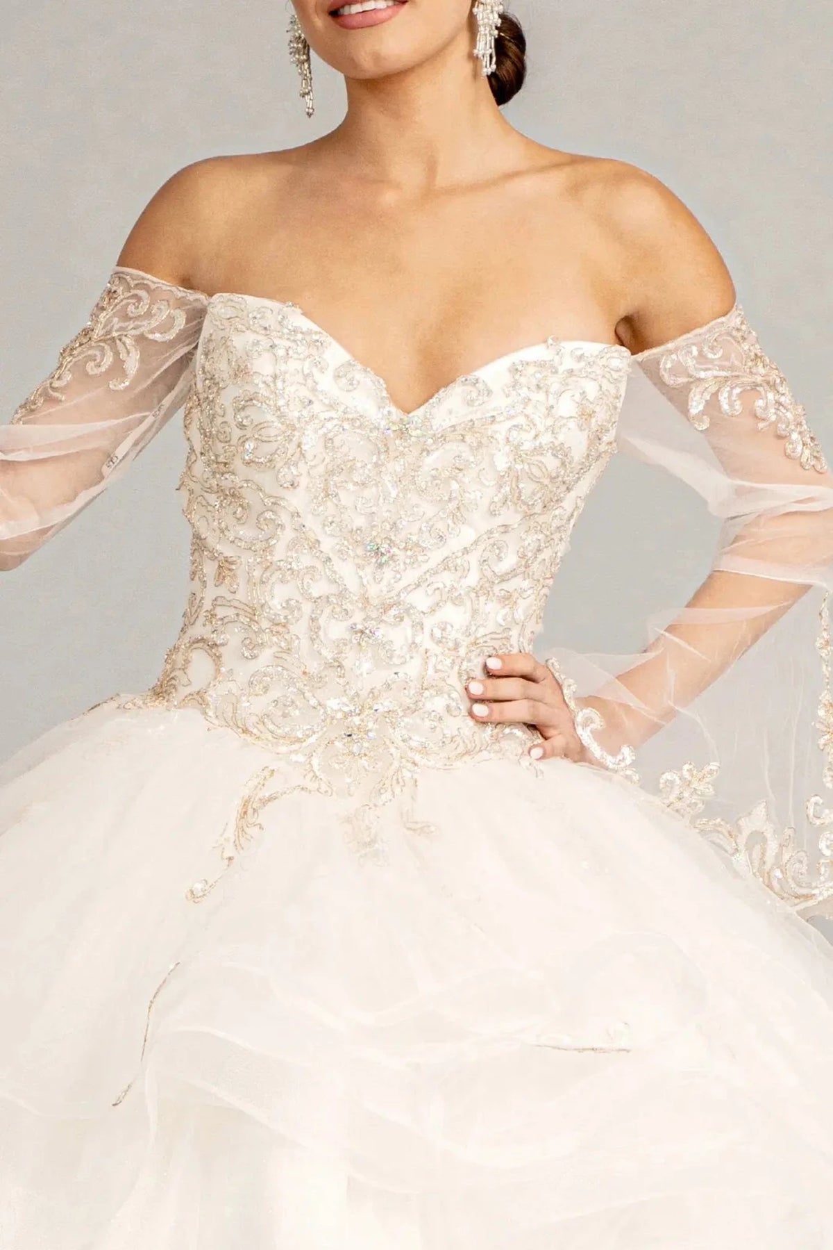 Full-length view presents the Off White quinceañera ball gown with long mesh sleeves.