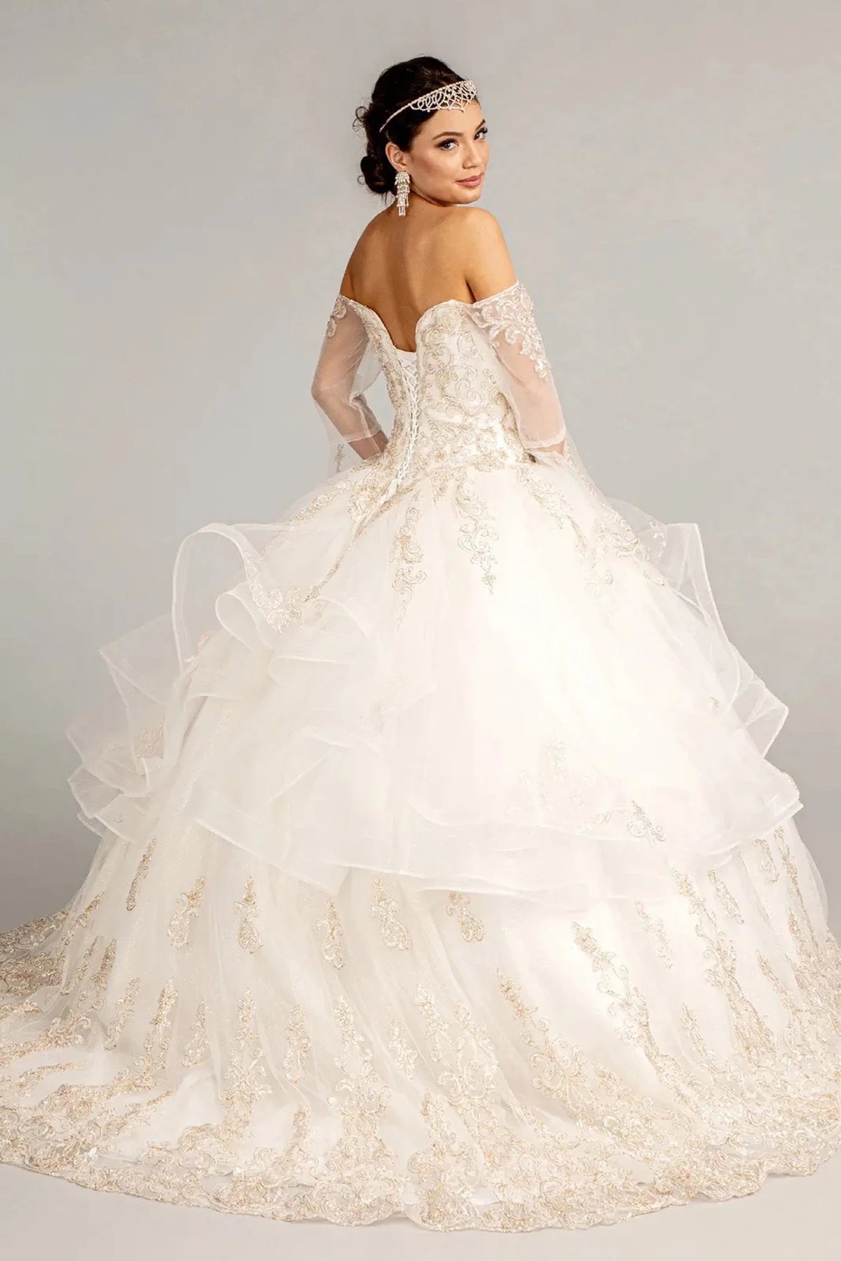 Bodice close-up highlights the Off White quinceañera ball gown with glitter embroidery.