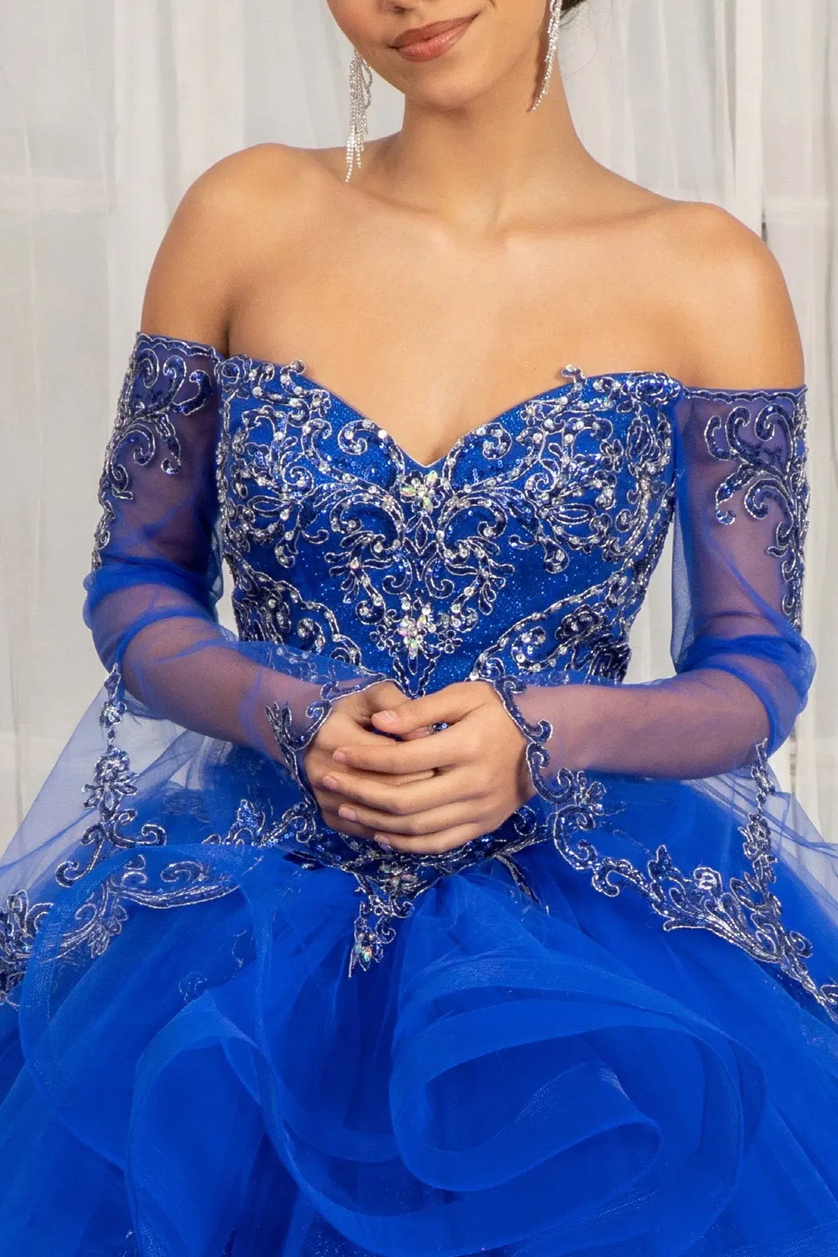 Full-length view presents the Royal Blue quinceañera ball gown with long mesh sleeves.