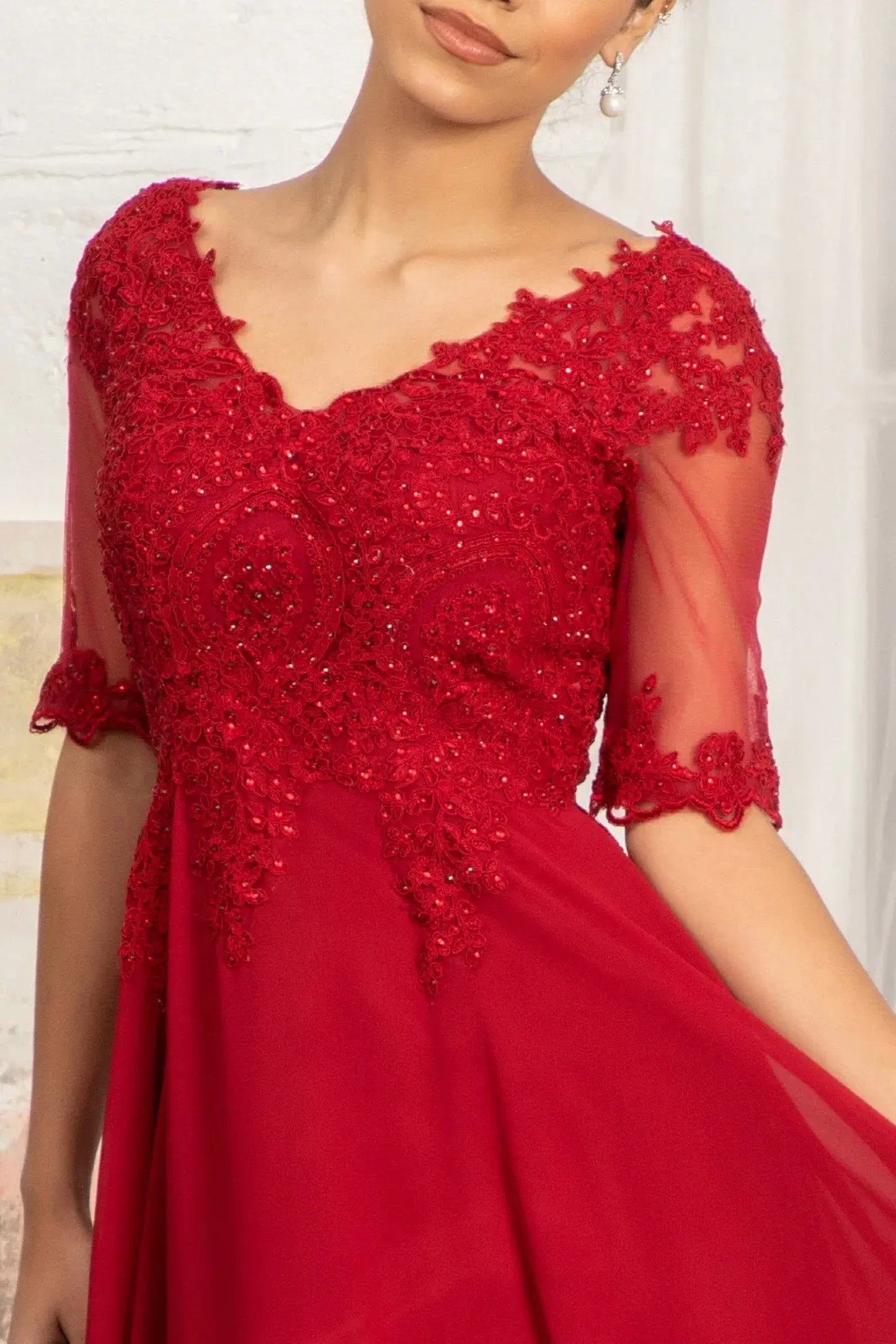 Burgundy mother of the bride dress featuring v-neckline bodice with short sleeves and rhinestones, embroidery, jewels, appliqués