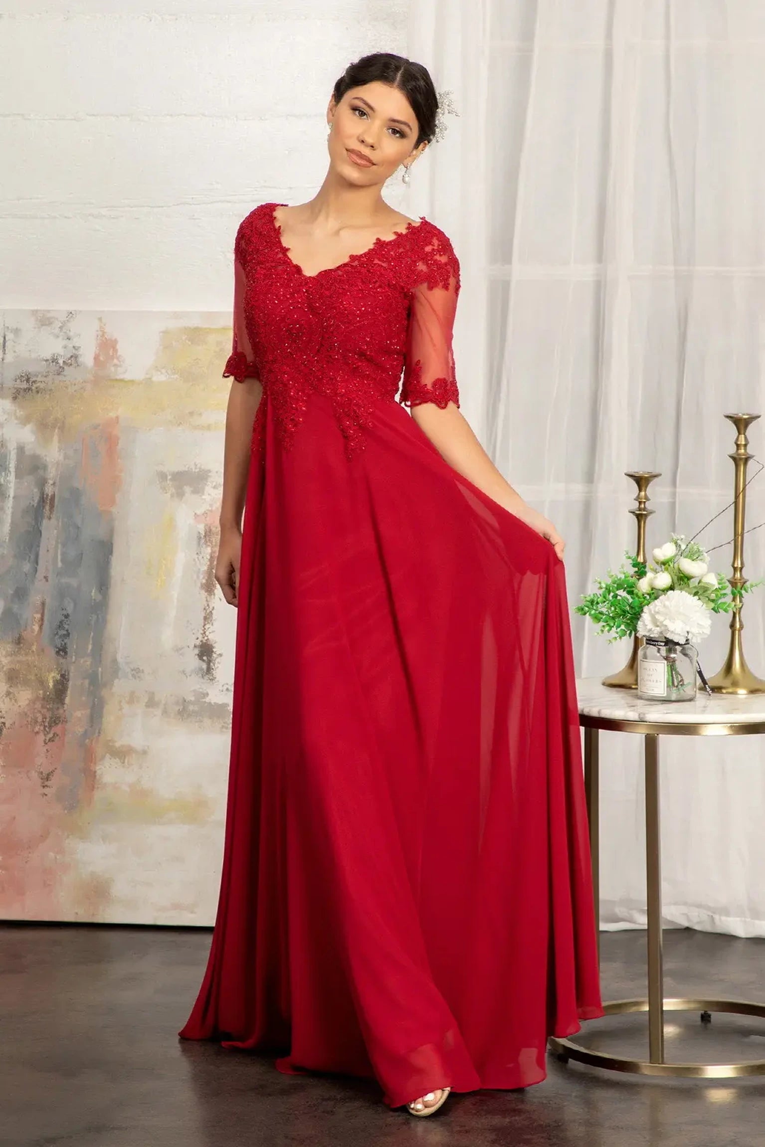 Burgundy mother of the bride dress featuring formal gown with v-neckline, short sleeves, and chiffon skirt