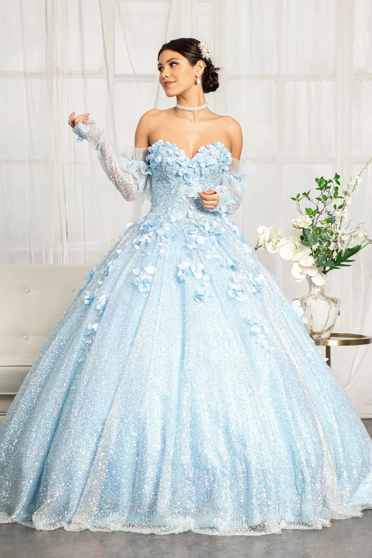 Lace-up back reveals the Baby Blue quinceañera ball gown with lace-up back and detachable long sleeves.