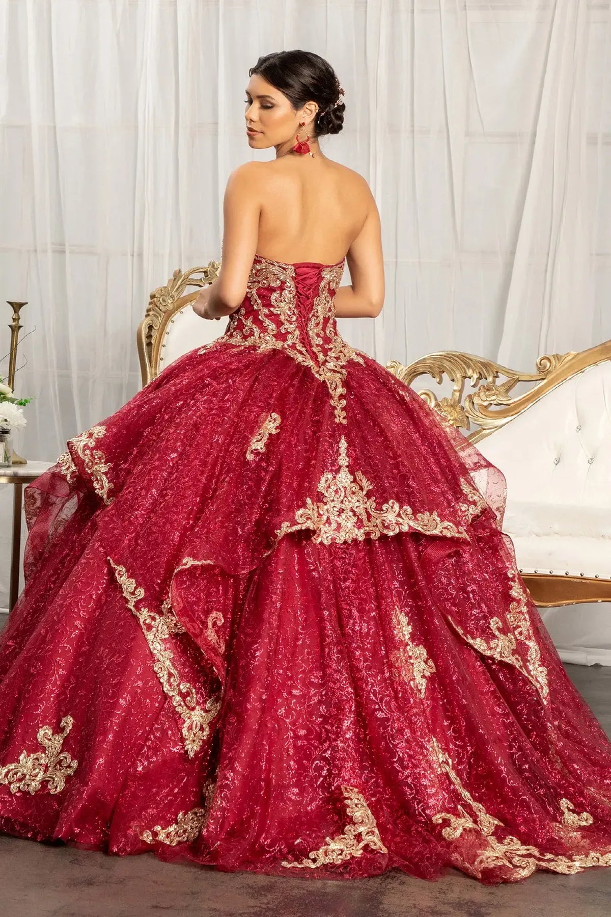 Bodice close-up highlights the Burgundy quinceañera ball gown with embroidered mesh skirt.
